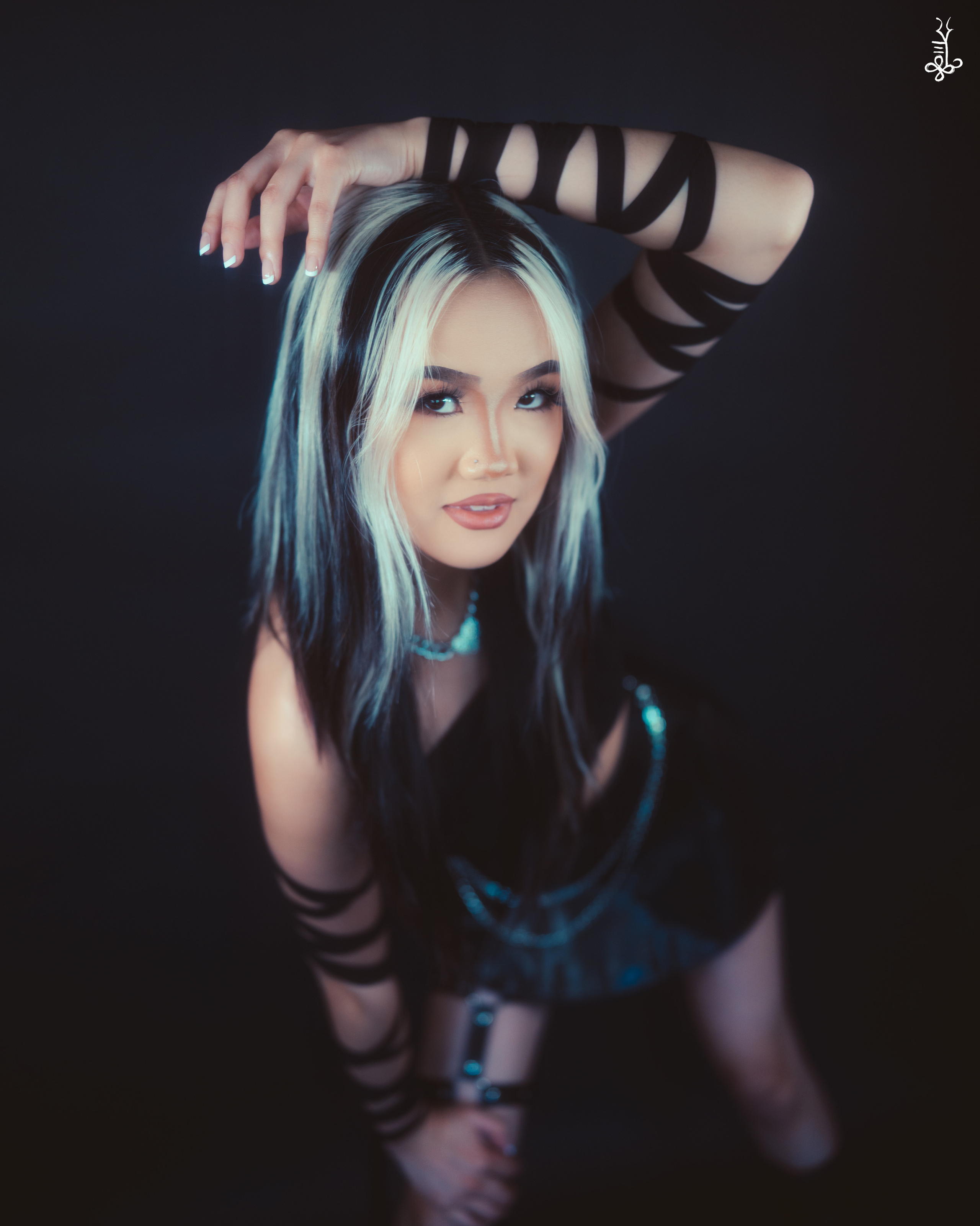 Close-up of model with dramatic makeup making claw hand gestures