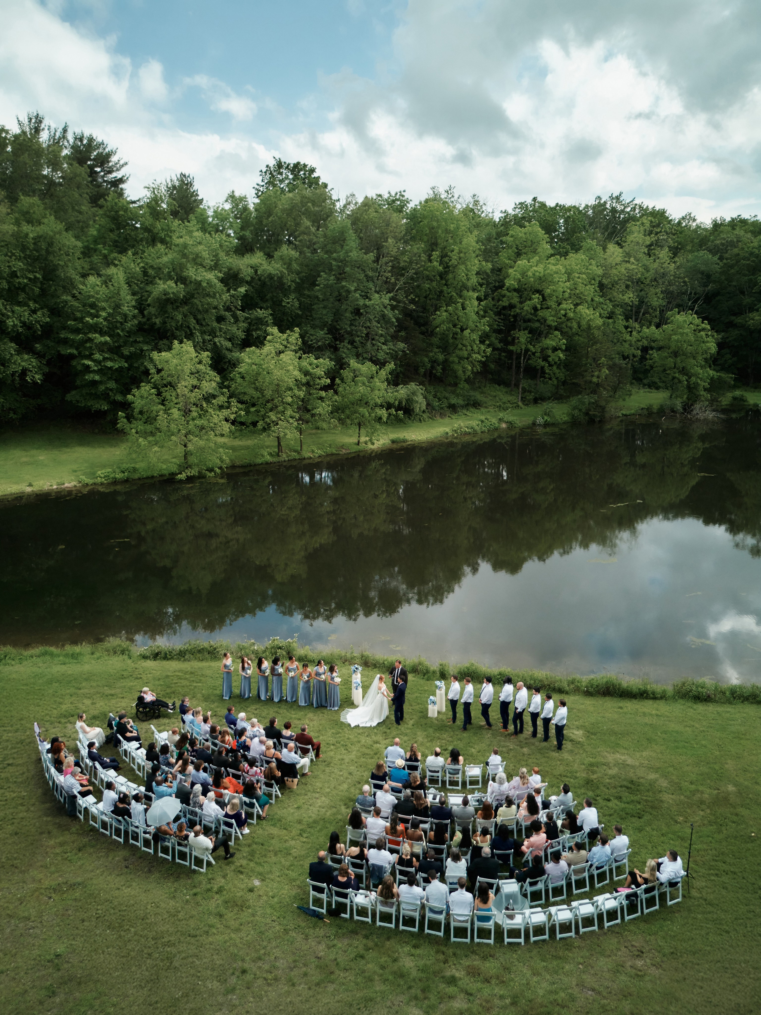 Outdoor wedding ceremony by the lake with guests seated in New Jersey