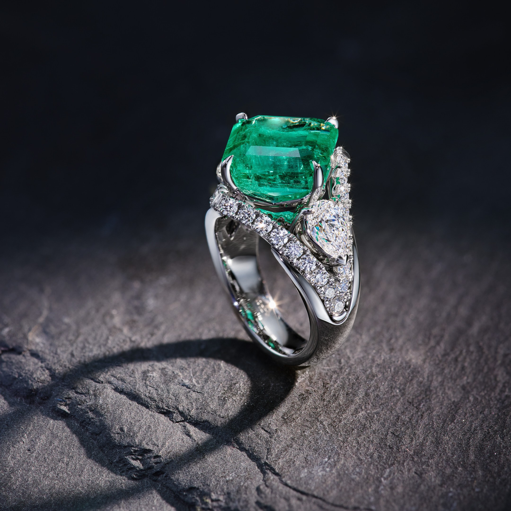Aleksander Sinitsyn jewelry ring with emerald and diamonds on dark grey stone background - photographer Andrey Dunin