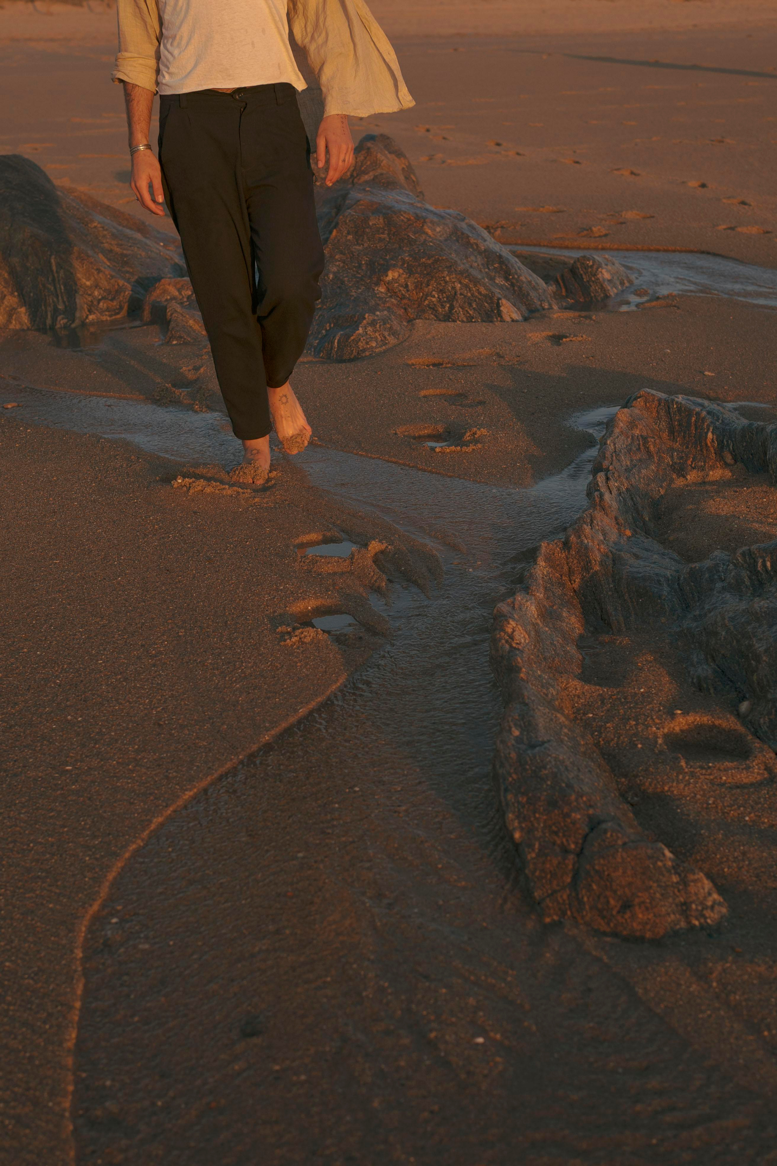 Feet in sunset light on a beach.