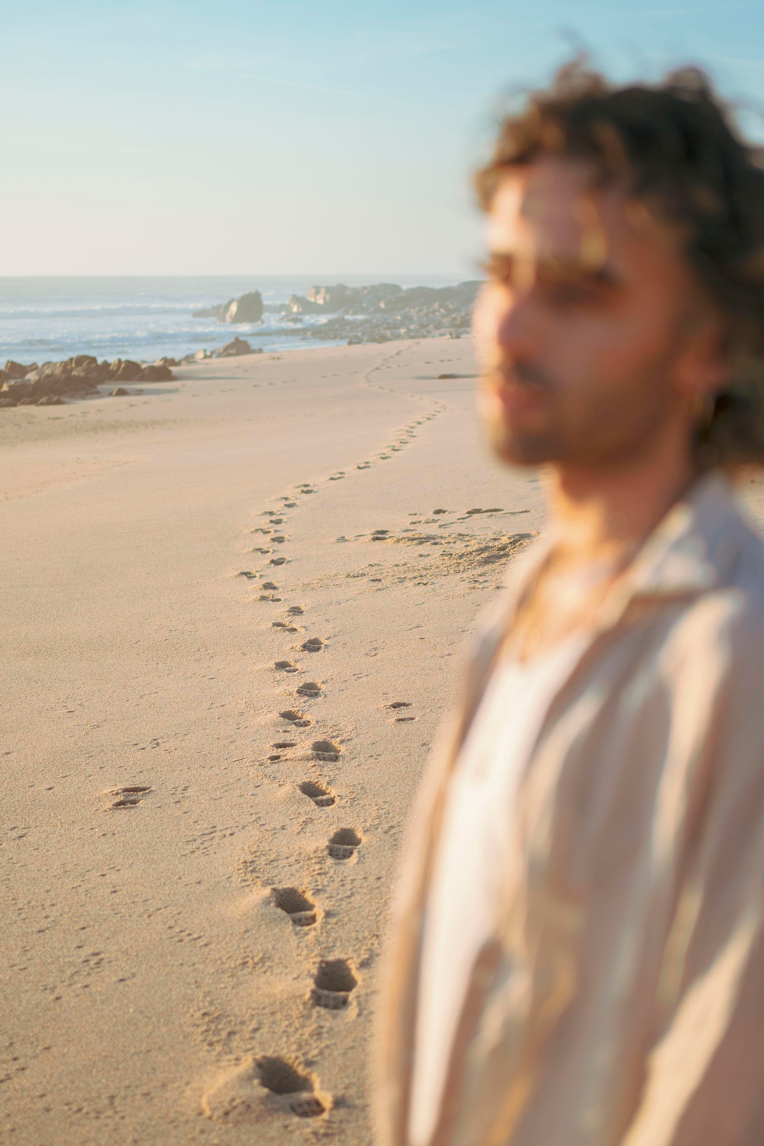 LGBTQ+, LGBT portrait of a beautiful person with makeup, a white tank top, and curly hair.