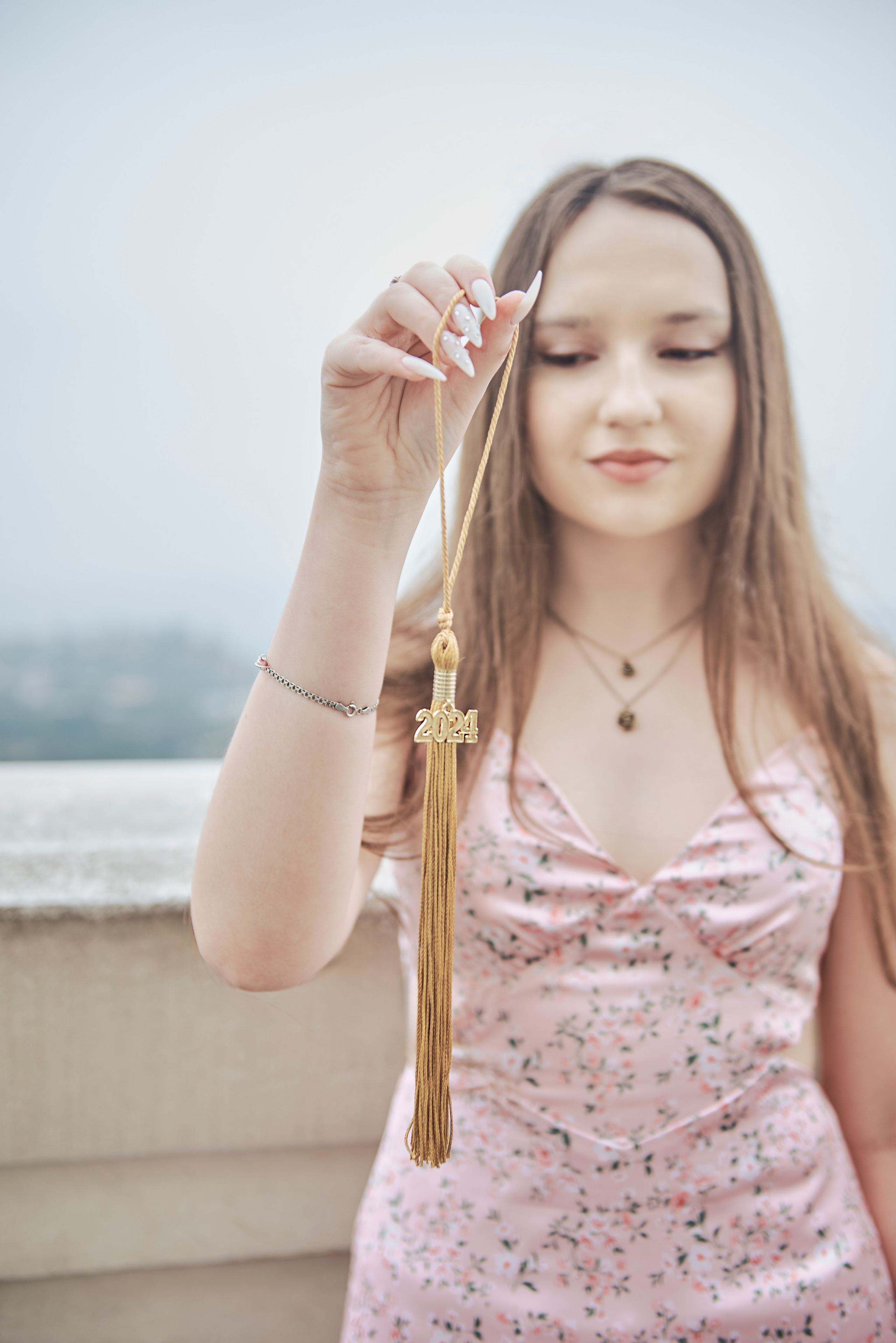 Graduate posing with friends in front of a Los Angeles art installation
