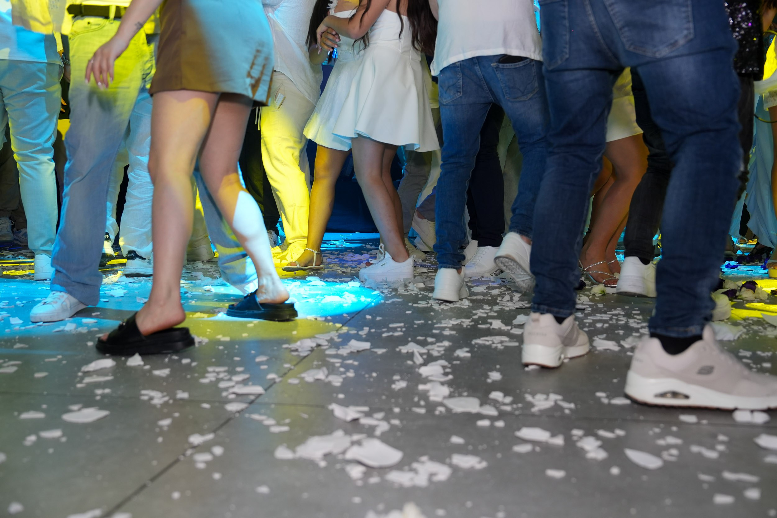 Low angle view of guests dancing on a floor covered with broken plates at Artista Event Garden in Hadera, Israel