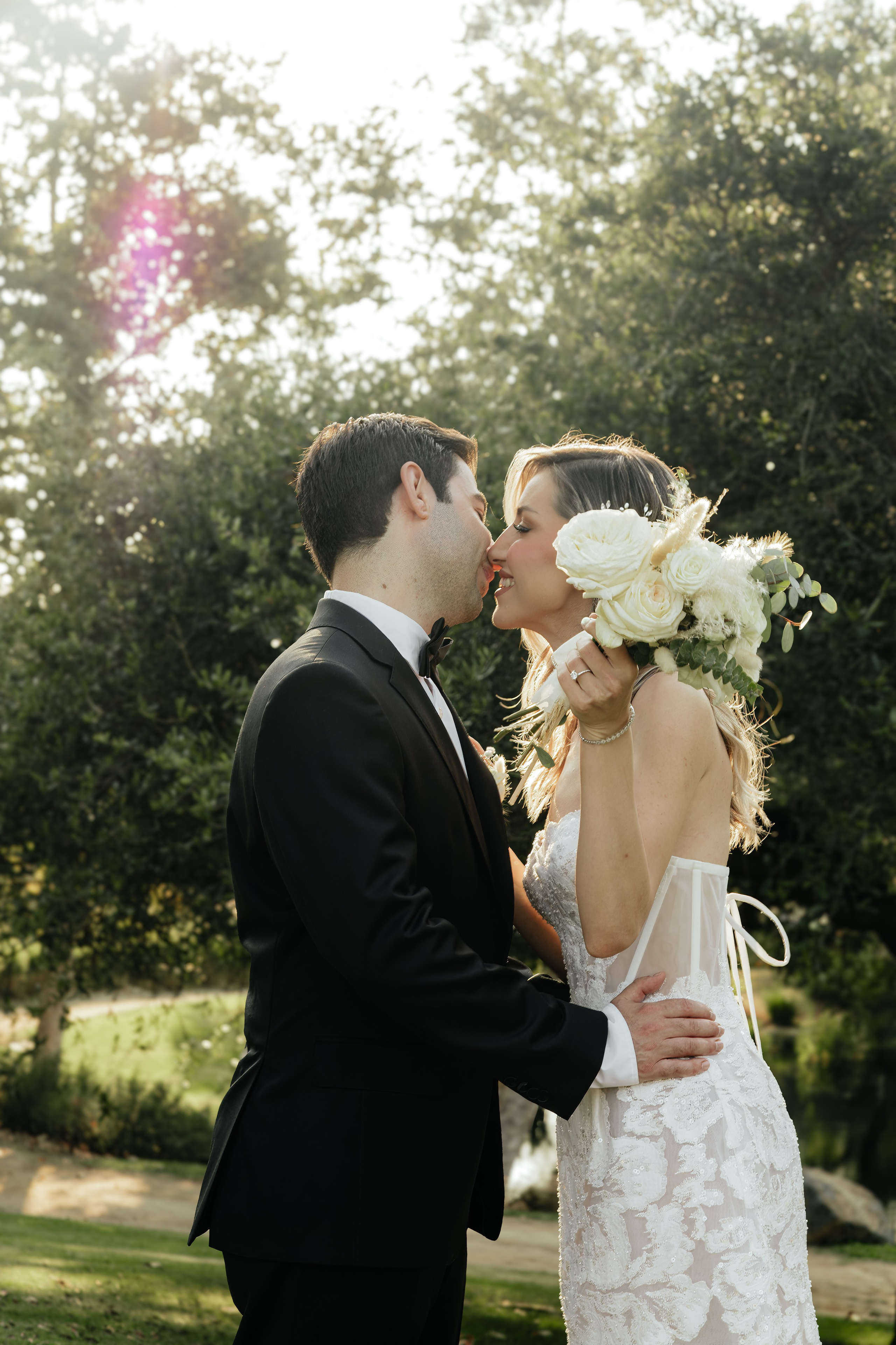 Bride and groom sharing a kiss in a Chicago park during wedding session