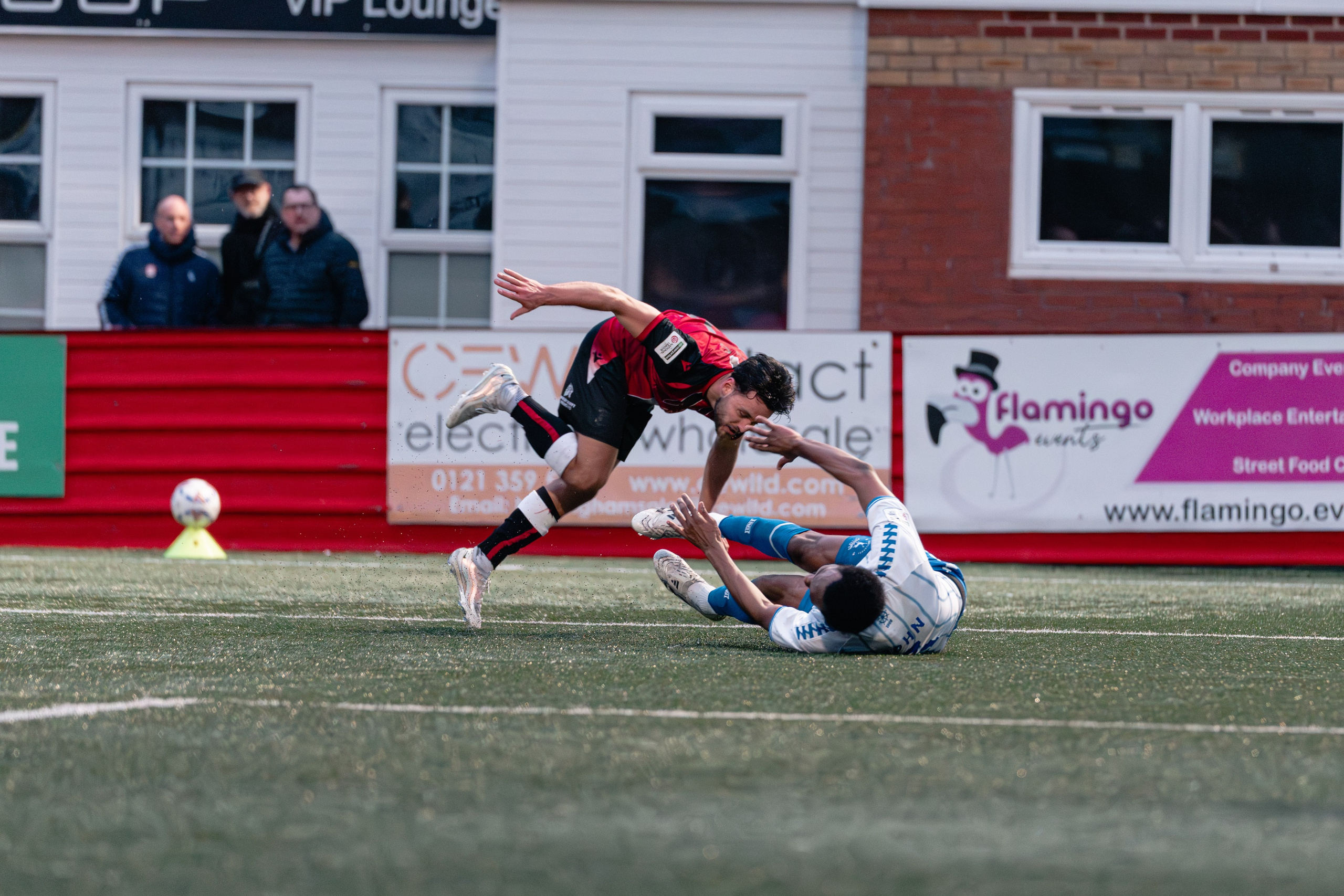 Stefan Mols of Tamworth is knocked off balance as Cameron John of Hartlepool slides in to challenge near the touchline.