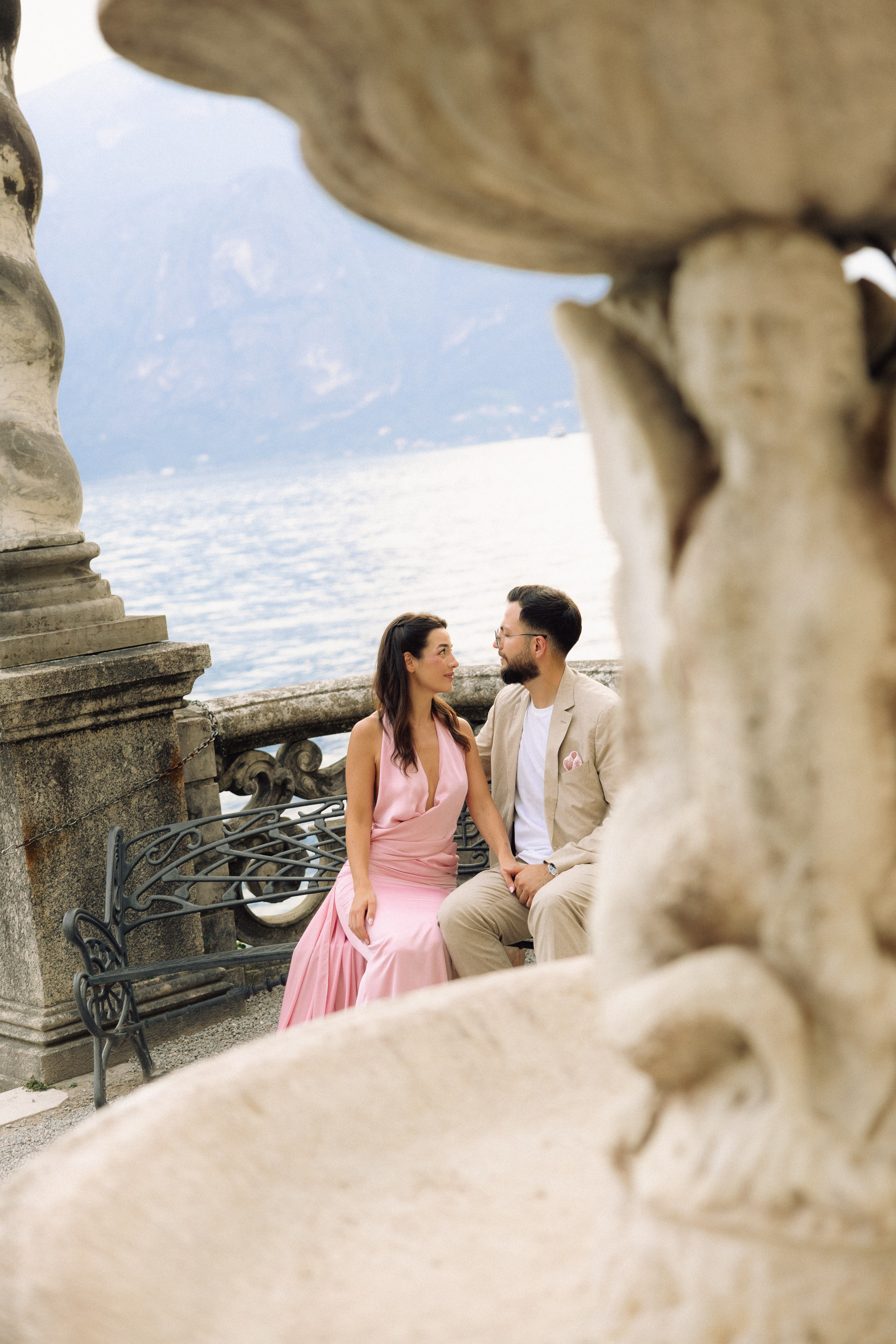 Couple holding hands during a romantic engagement on Lake Como