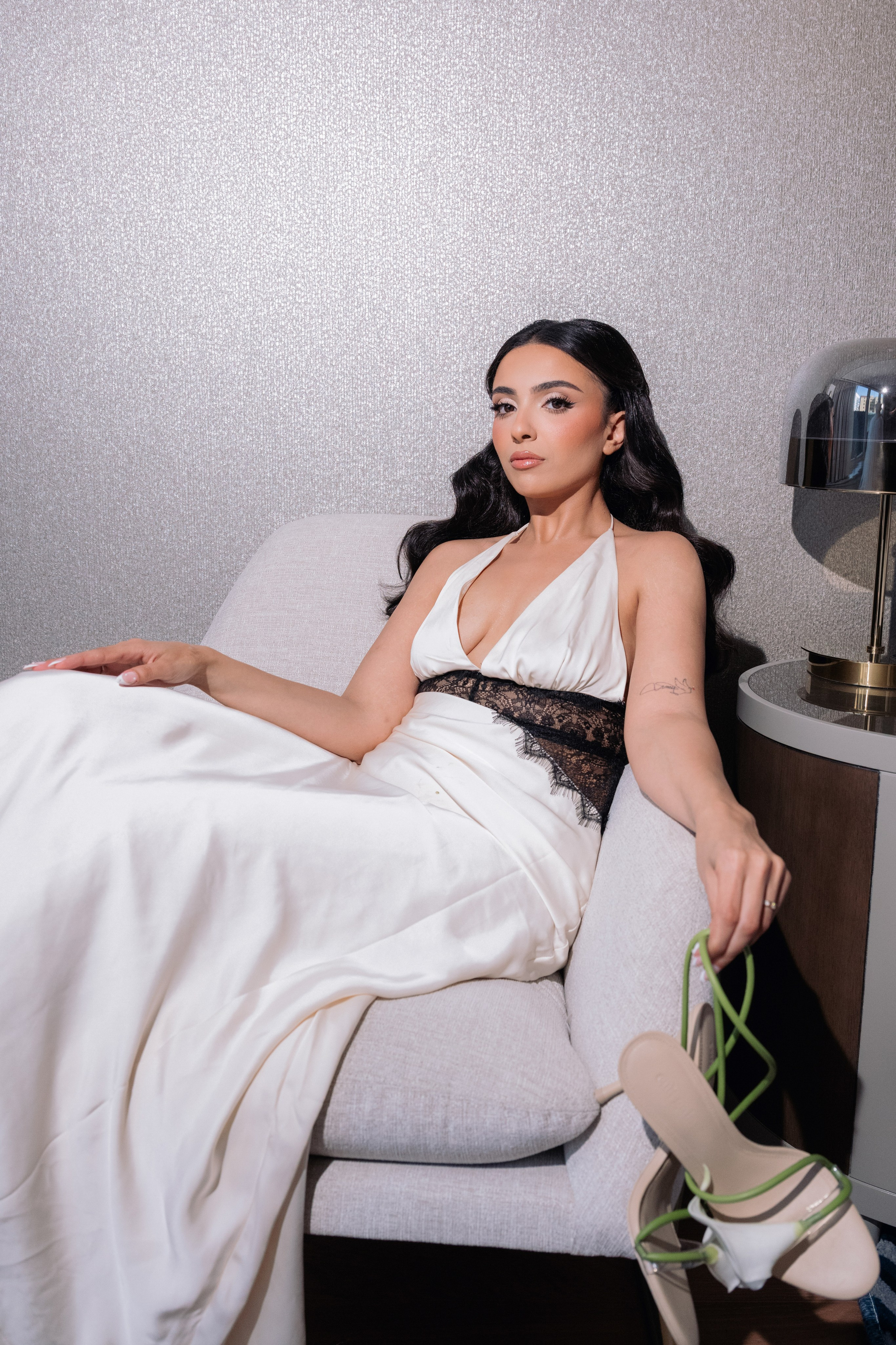 	Bride sitting by the window in a bright bridal suite