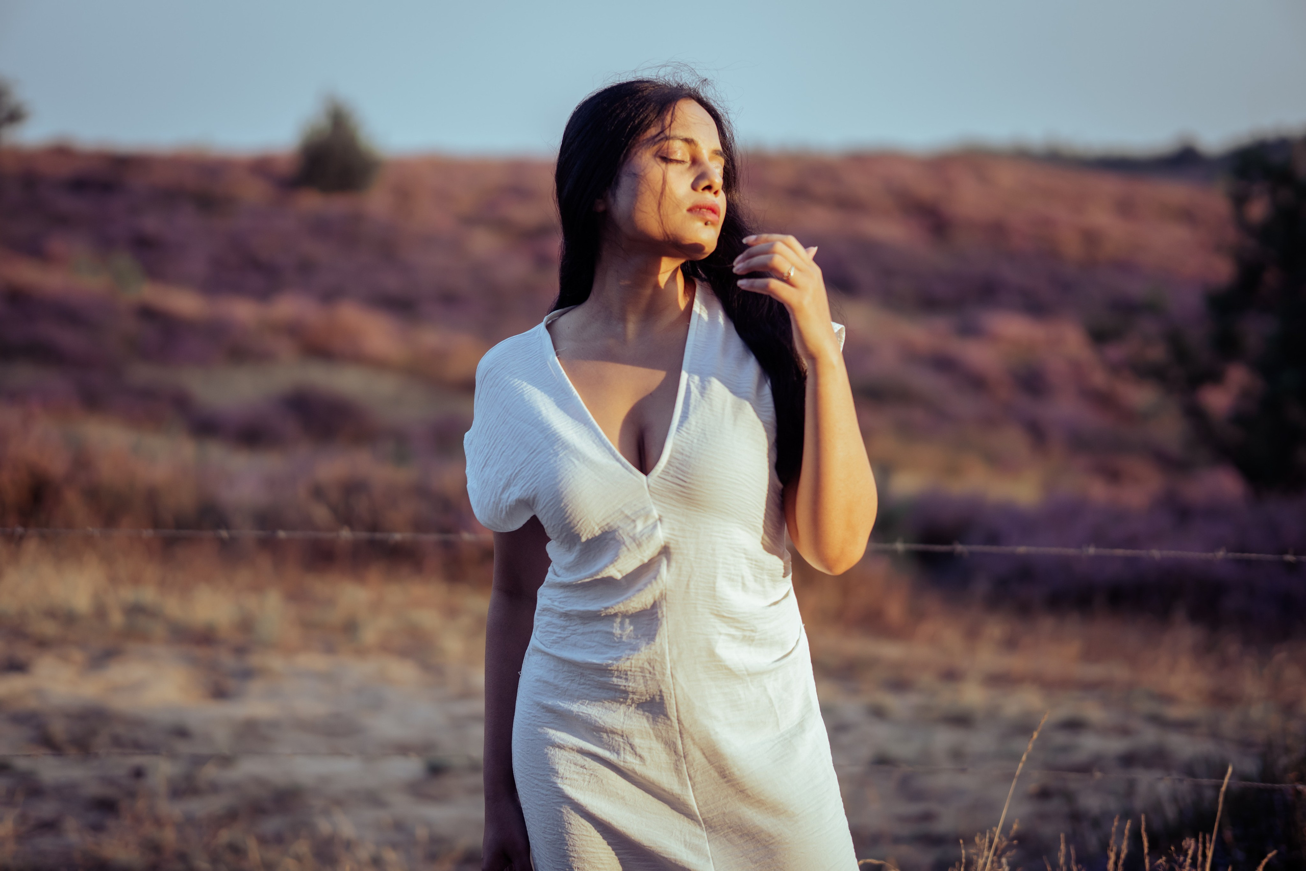 girl standing in heather fields