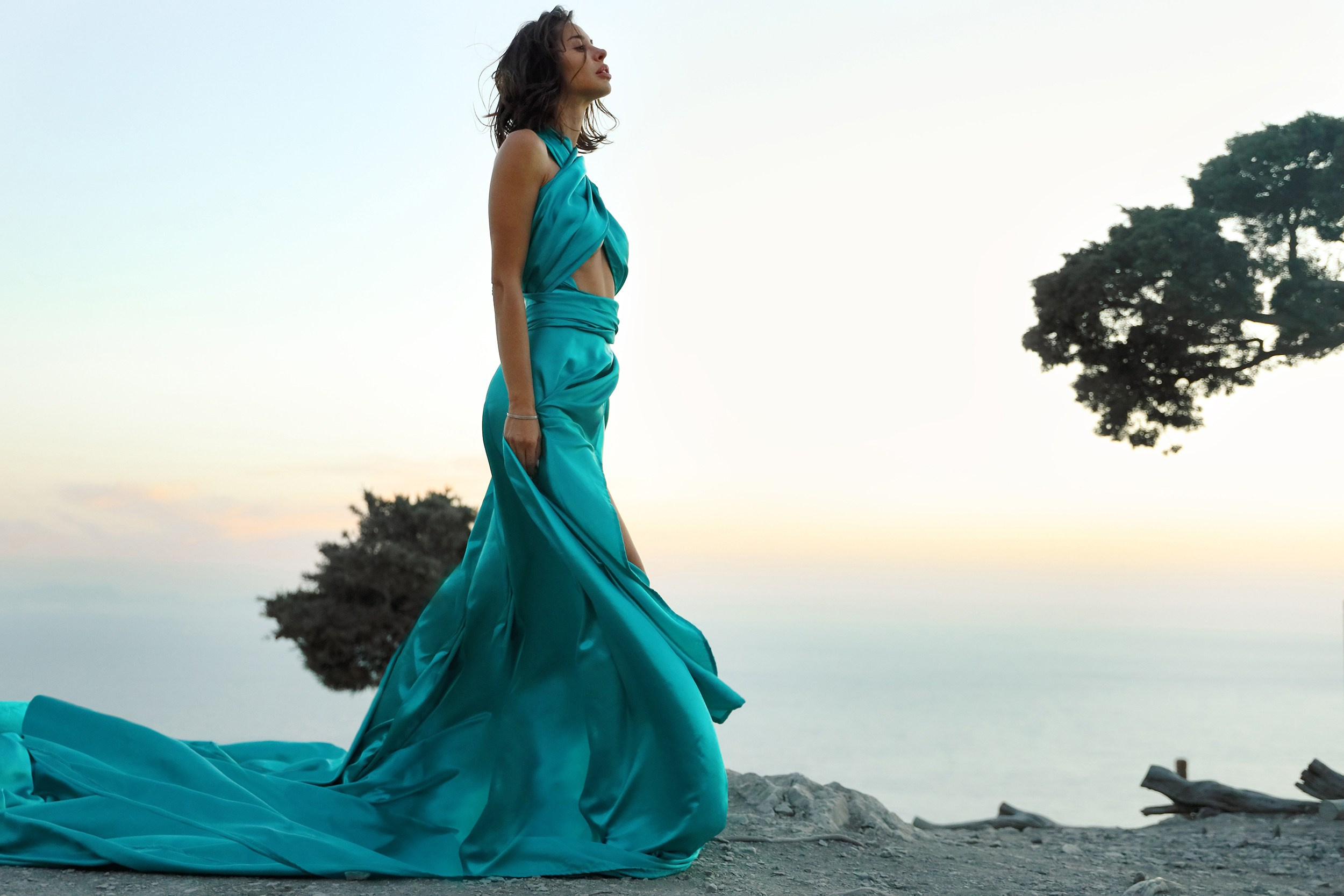 An art photo shoot of a girl in a flying dress in Monolithos castle in Rhodes, Greece