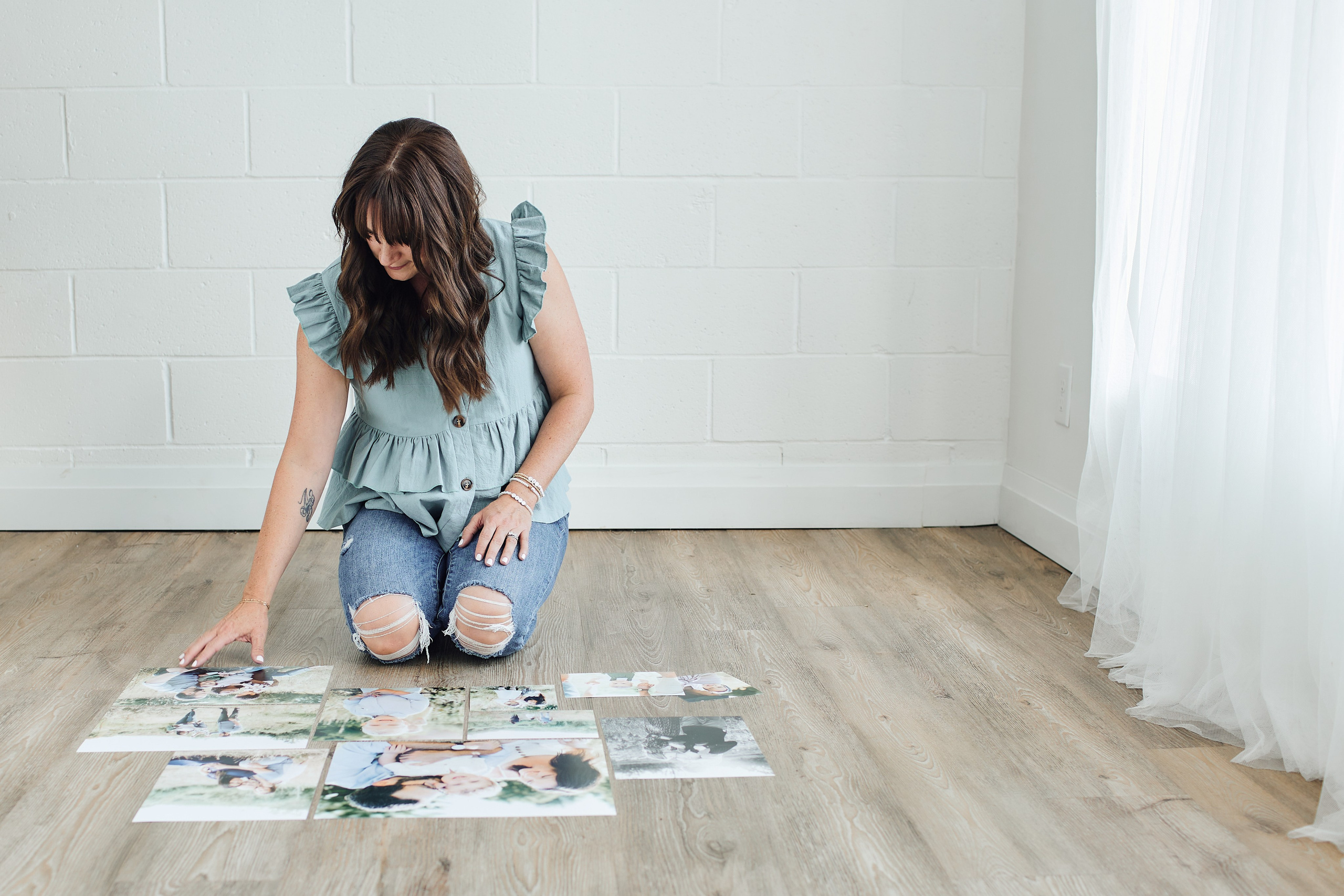 photographer sitting on floor sorting photos 