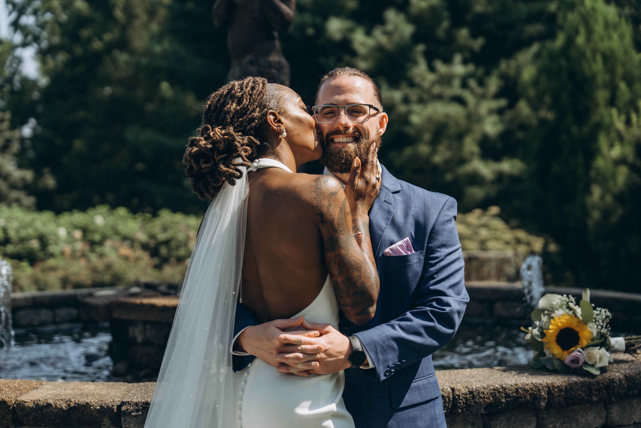 Candid photo of bride and groom laughing during wedding toast