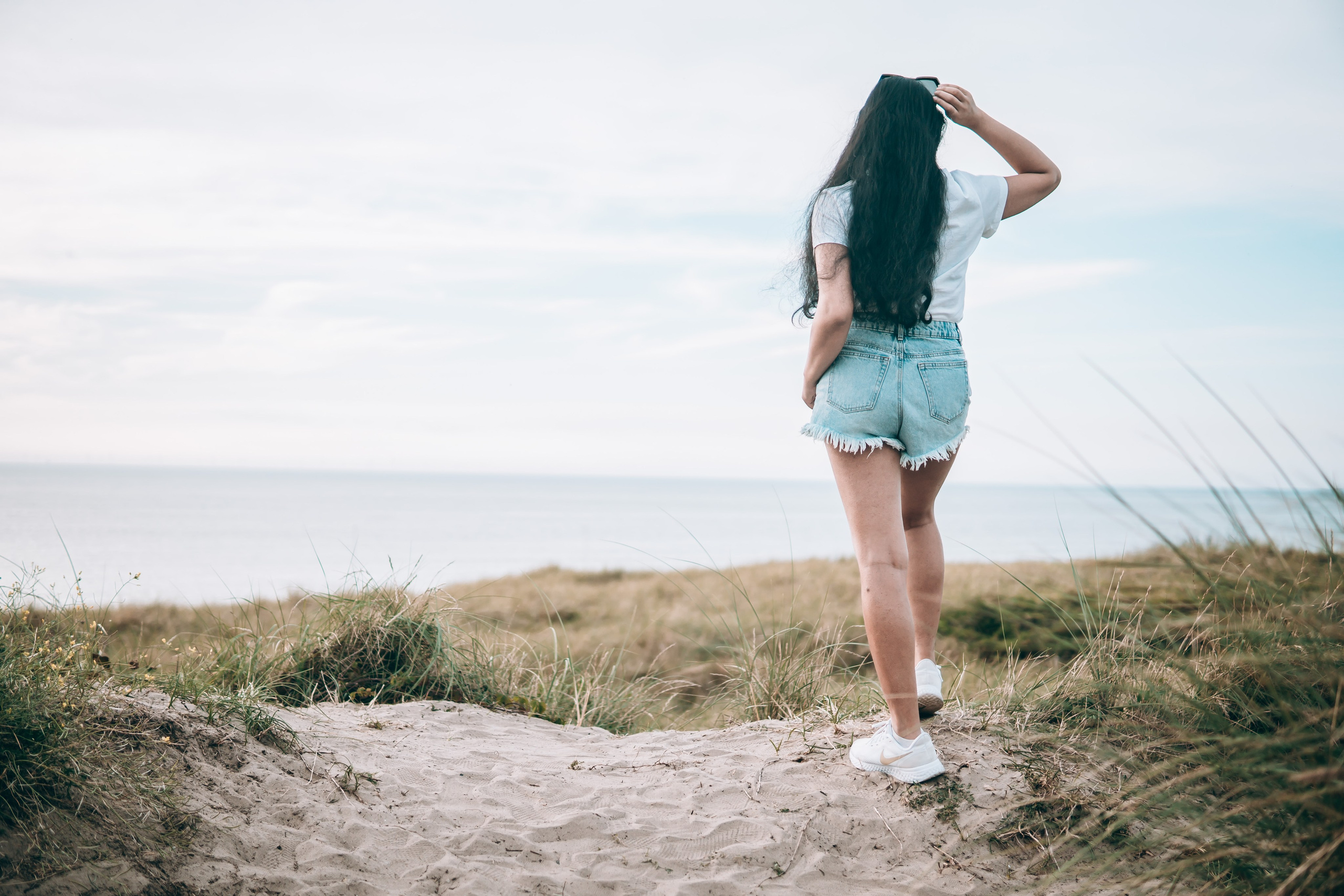 Woman staring at the sea in the Netherlands
