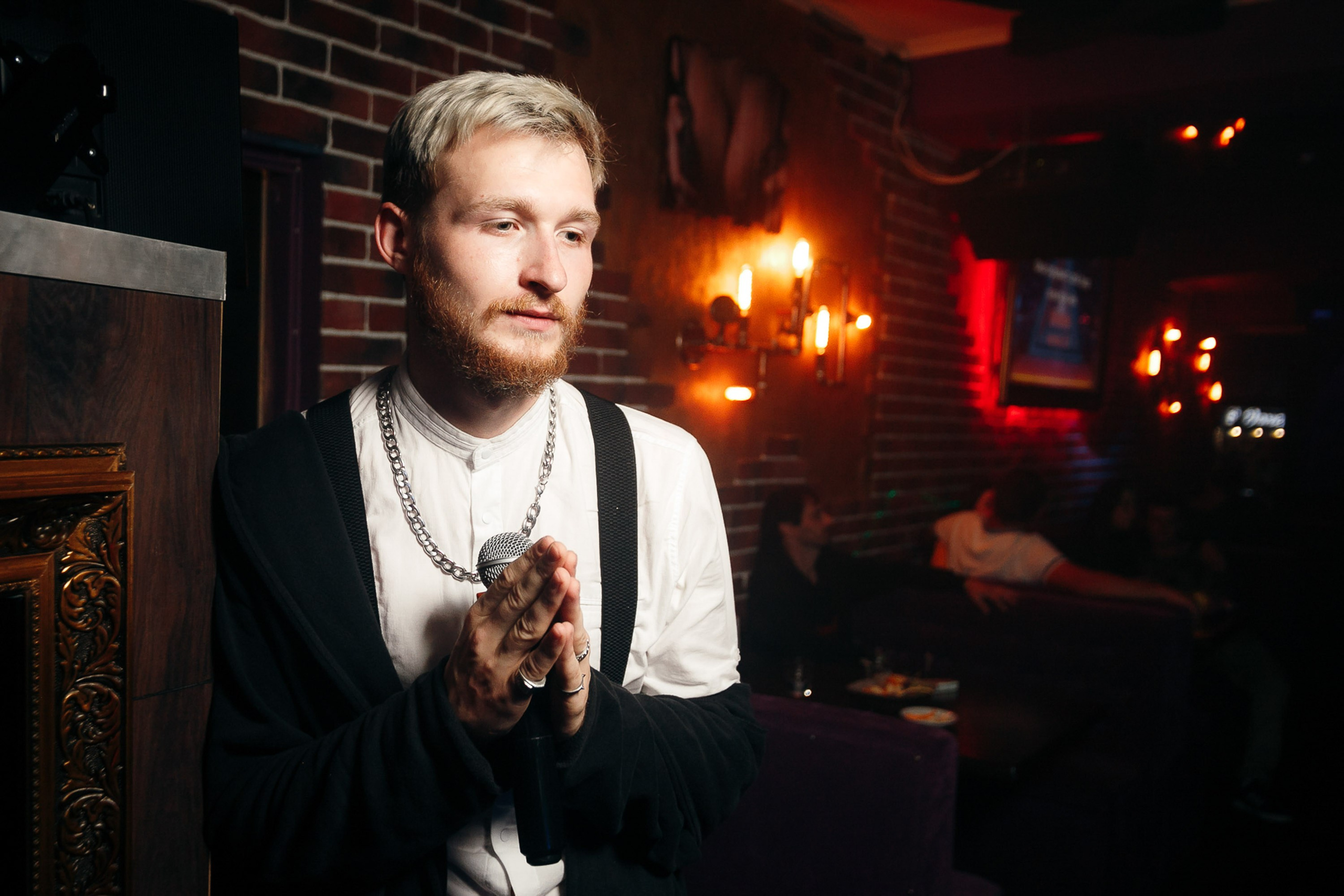Man in formal suit at bar with warm lighting
