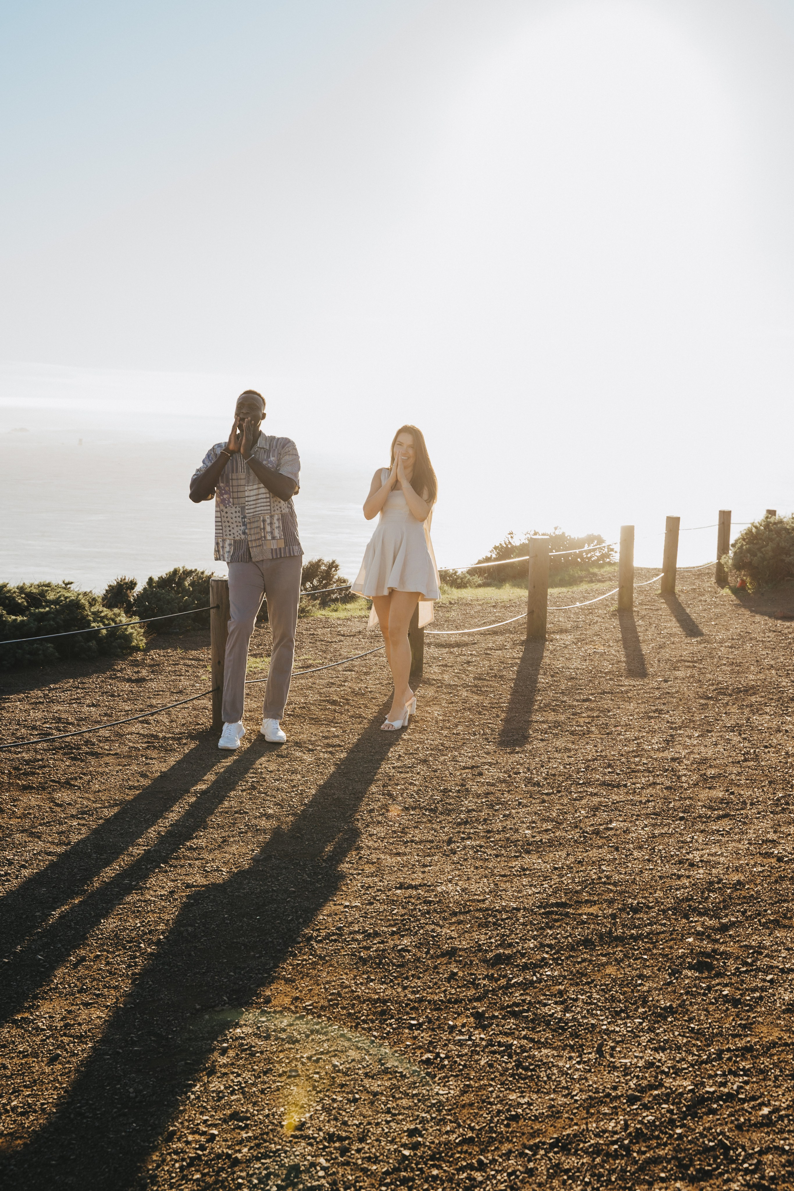 Proposal.  Overlooking the golden San Franisco Bridge sunset with a couple. Photographer Video. 