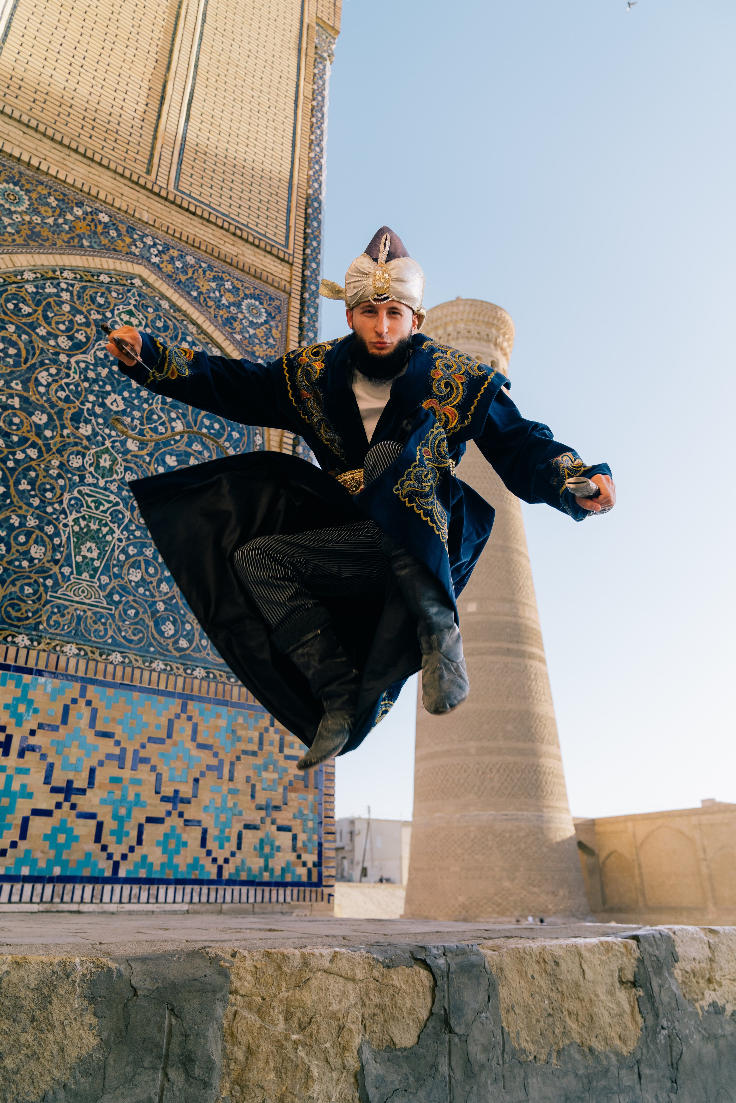 Man in traditional attire against the backdrop of Bukhara