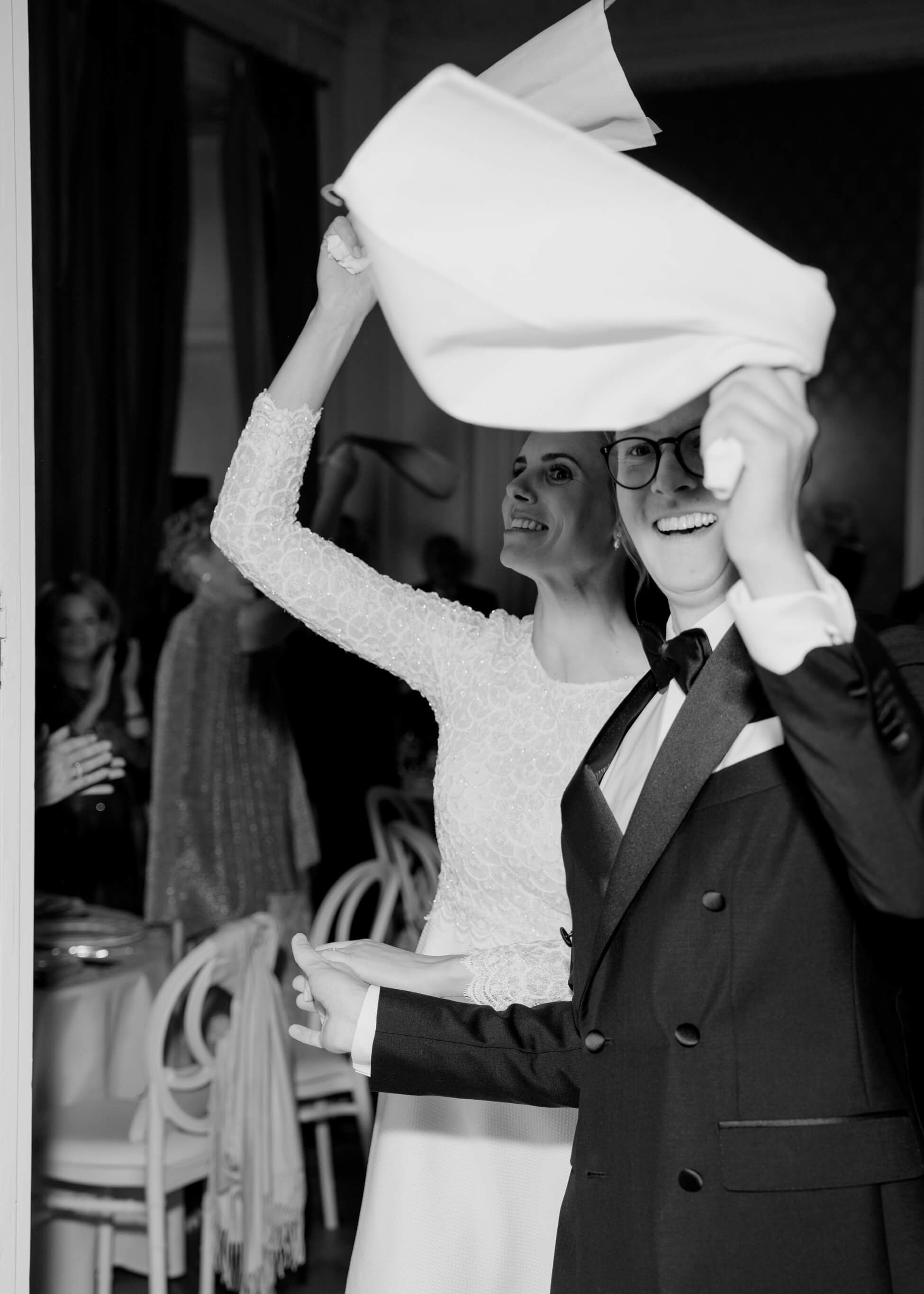 Bride and groom celebrating together waving white napkins at luxury wedding dinner, Villa Rothschild Frankfurt