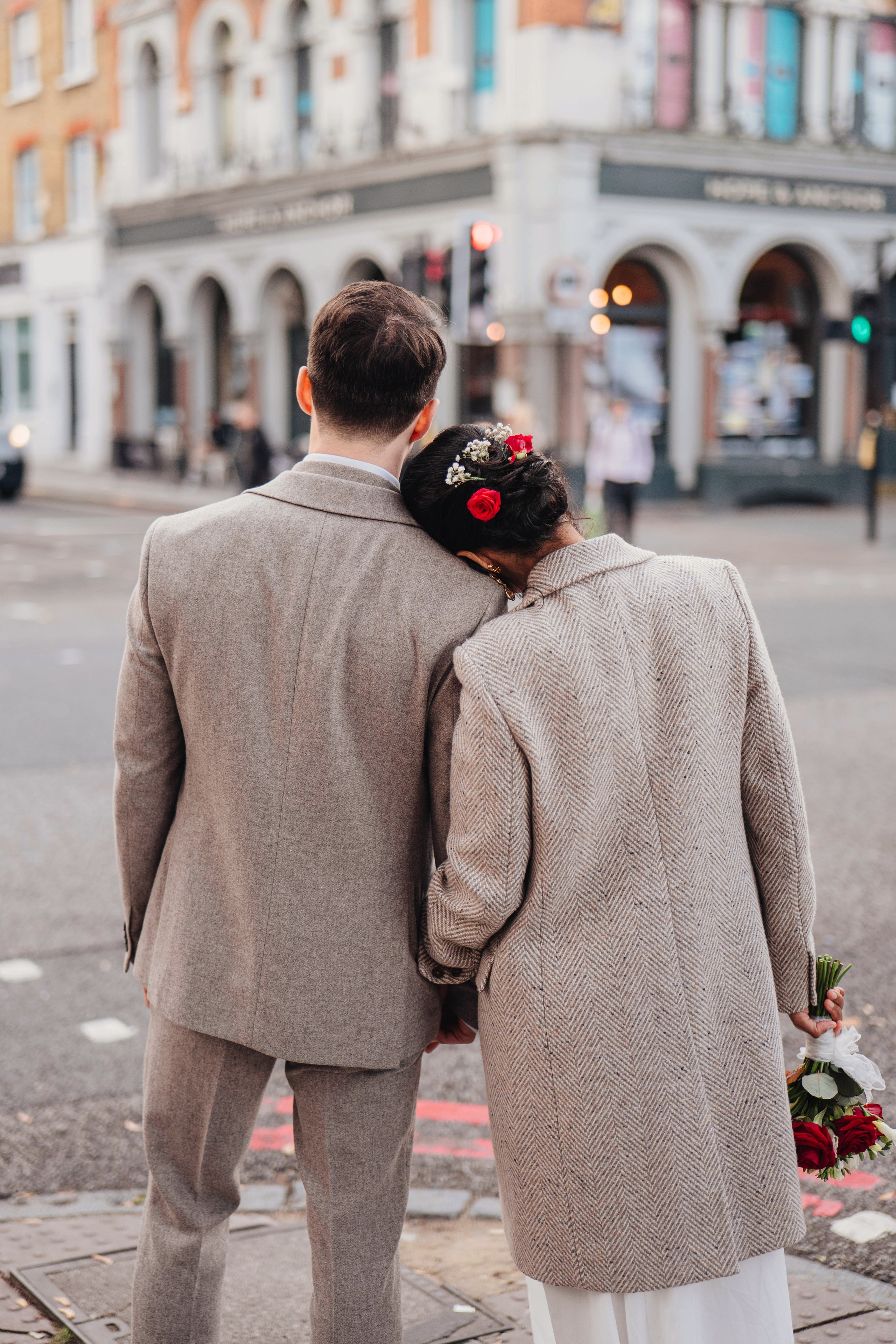 Wedding in Islington town hall couple from the back on the road crossing