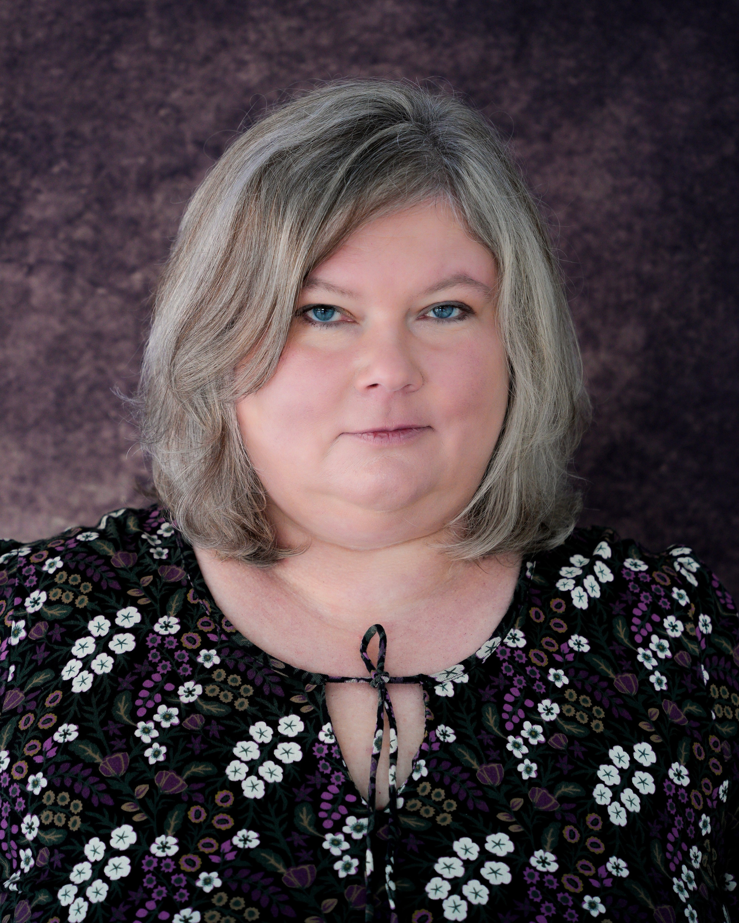 Natural headshot of a woman with a calm, confident expression, photographed in Solihull.
