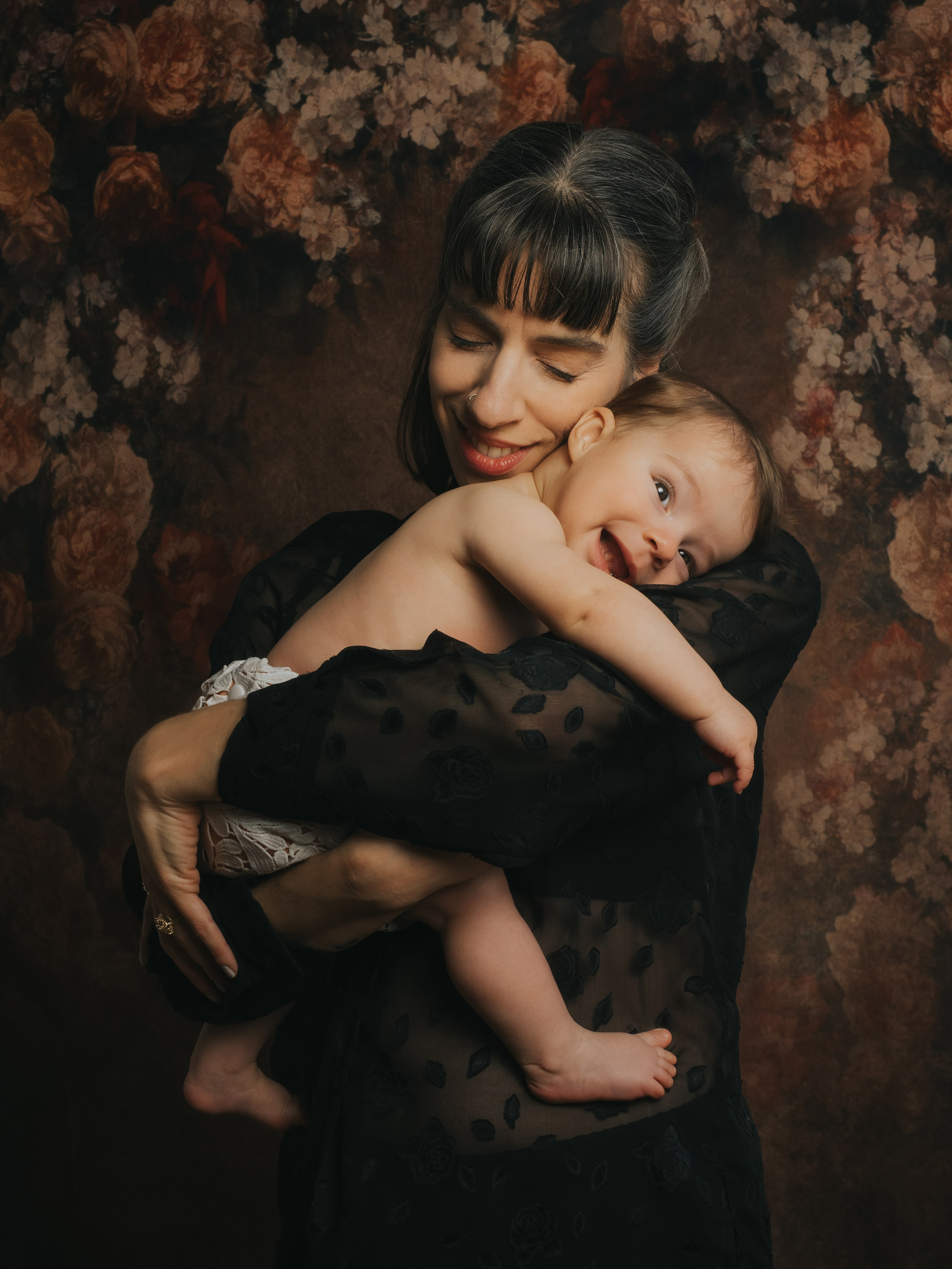 Mom and baby giving each other a hug.