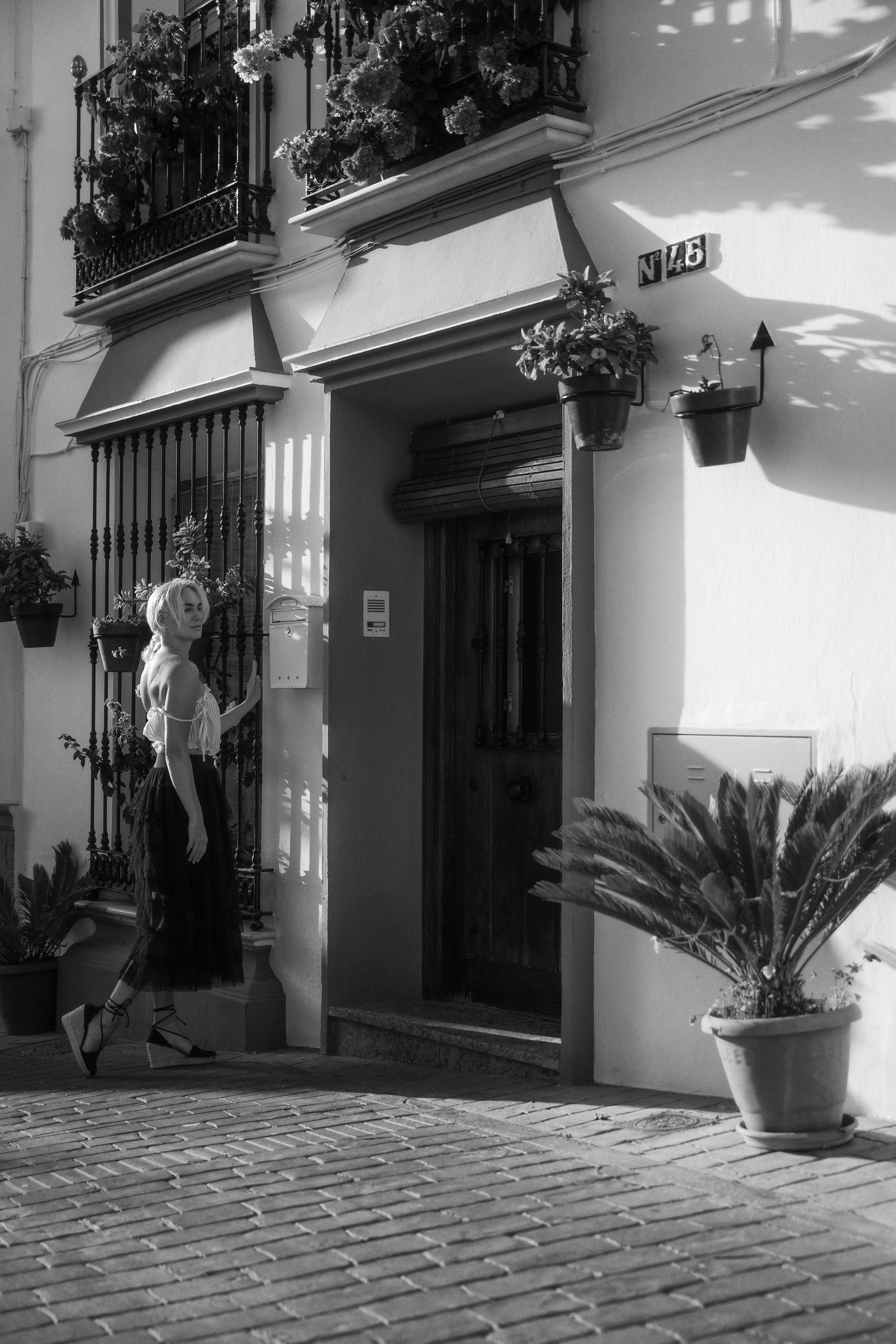 Blonde model posing in Estepona historic old town, photographed by a Marbella-based portrait photographer