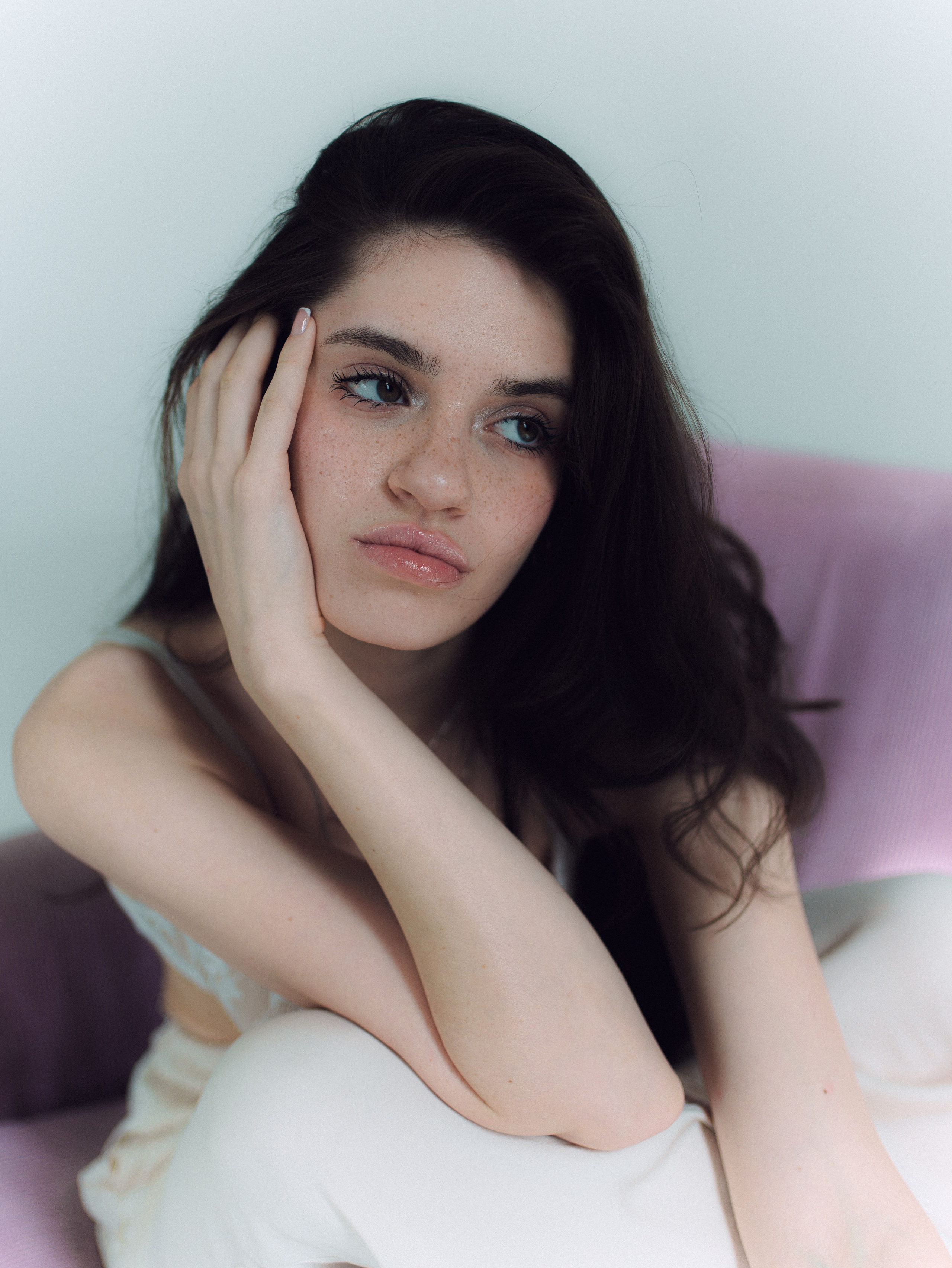 Minimal portrait with relaxed expression in white soft light