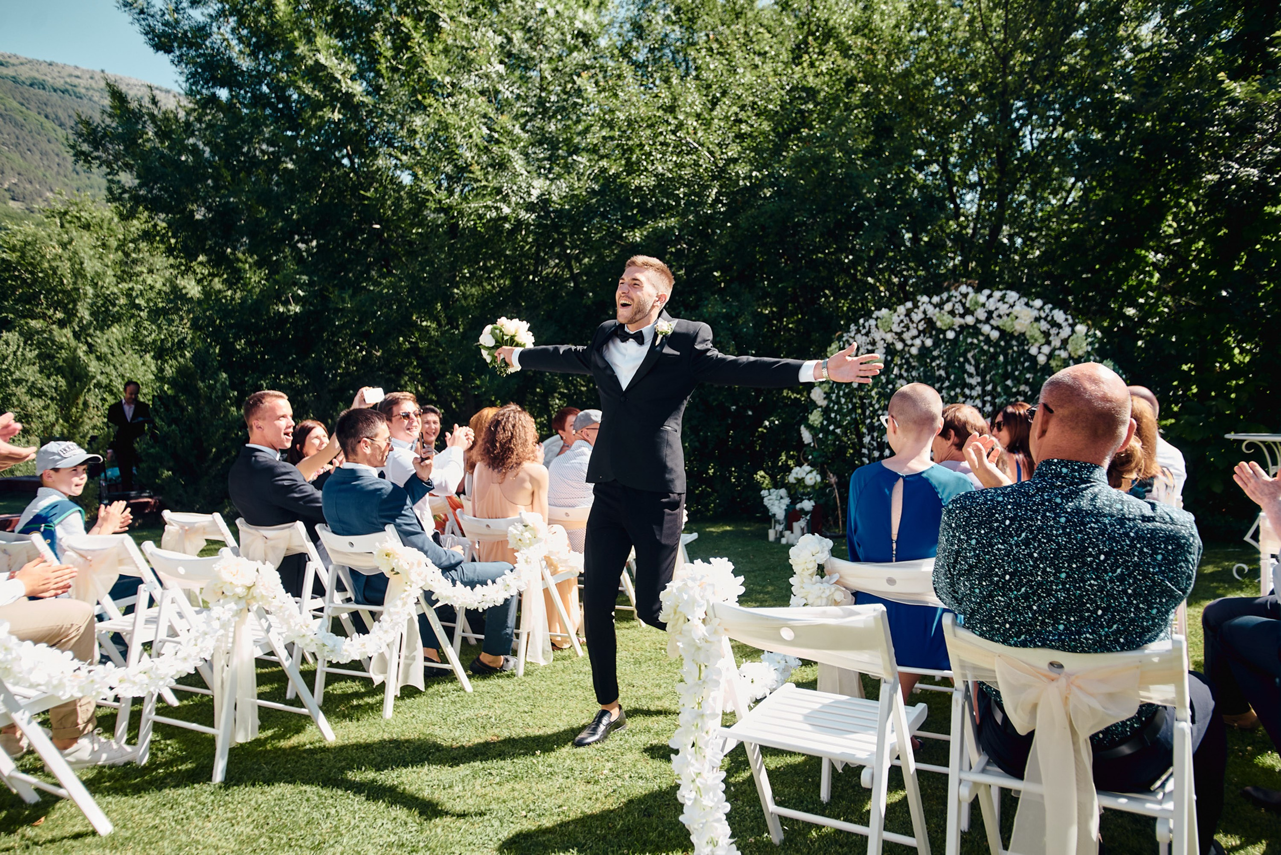 Outdoor wedding reception with guests at tables
