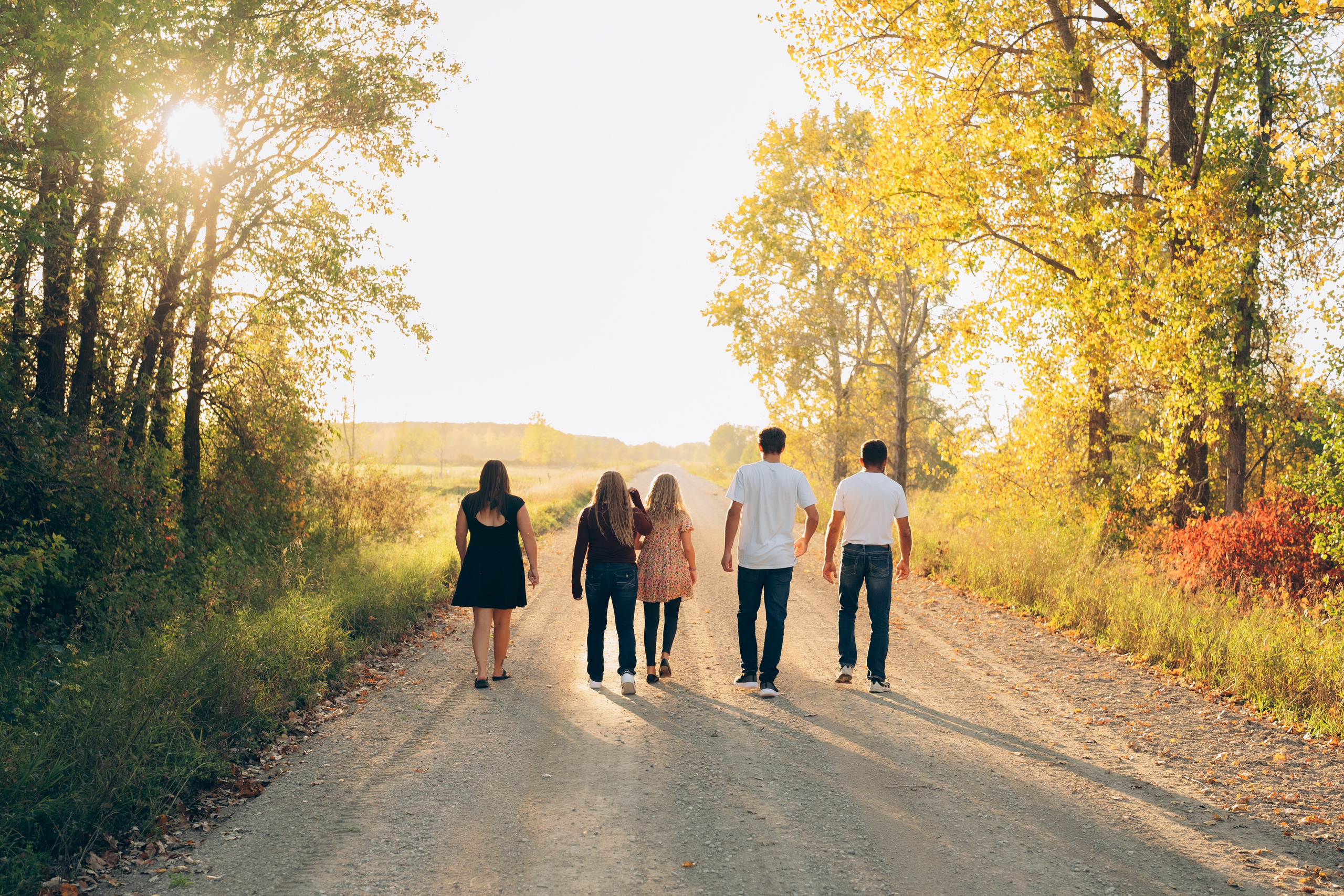Family framed by tall trees