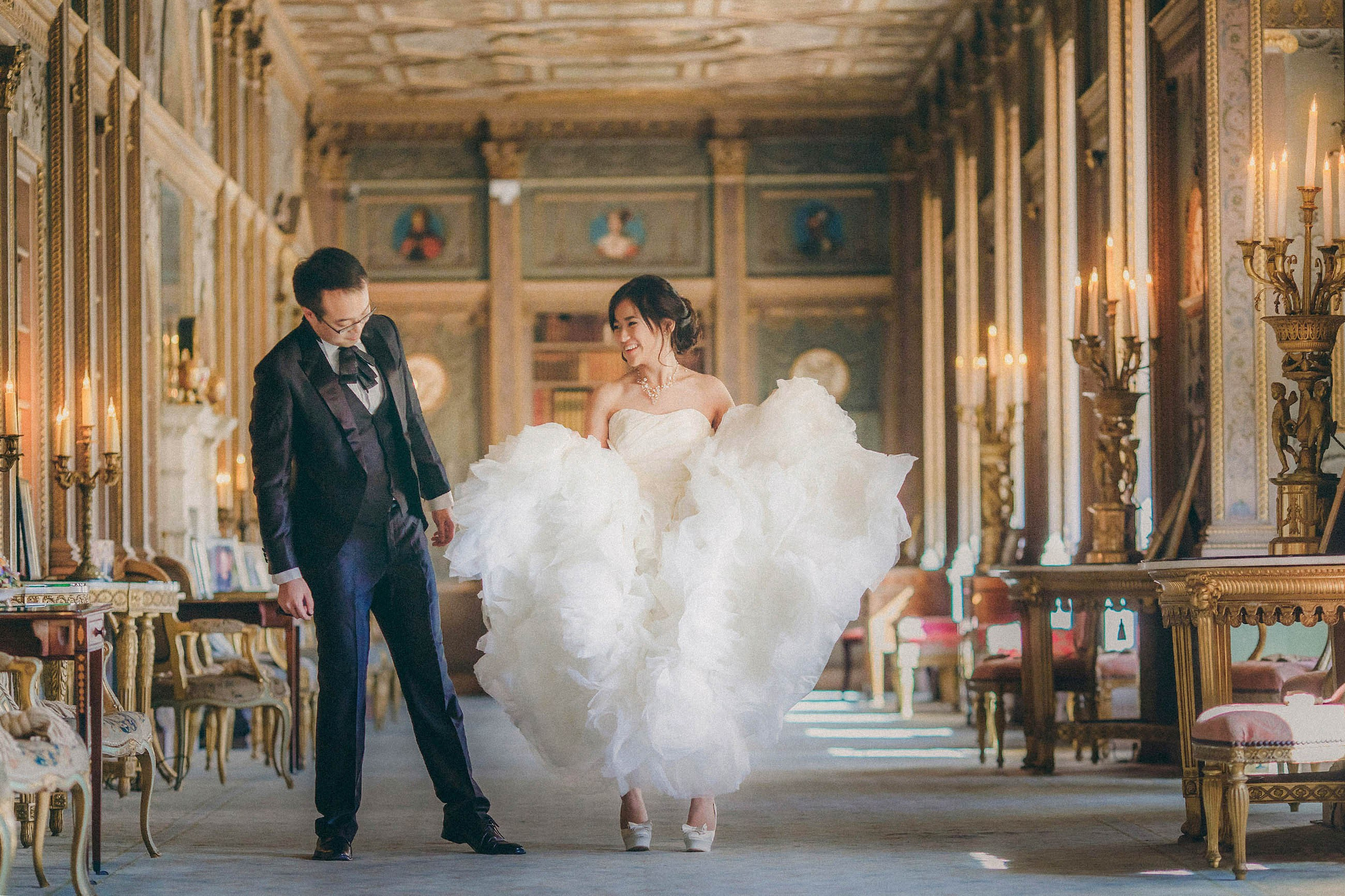 Chic Hong Kong bride presenting Jimmy Choo shoes to her groom at their wedding at Syon House, London.