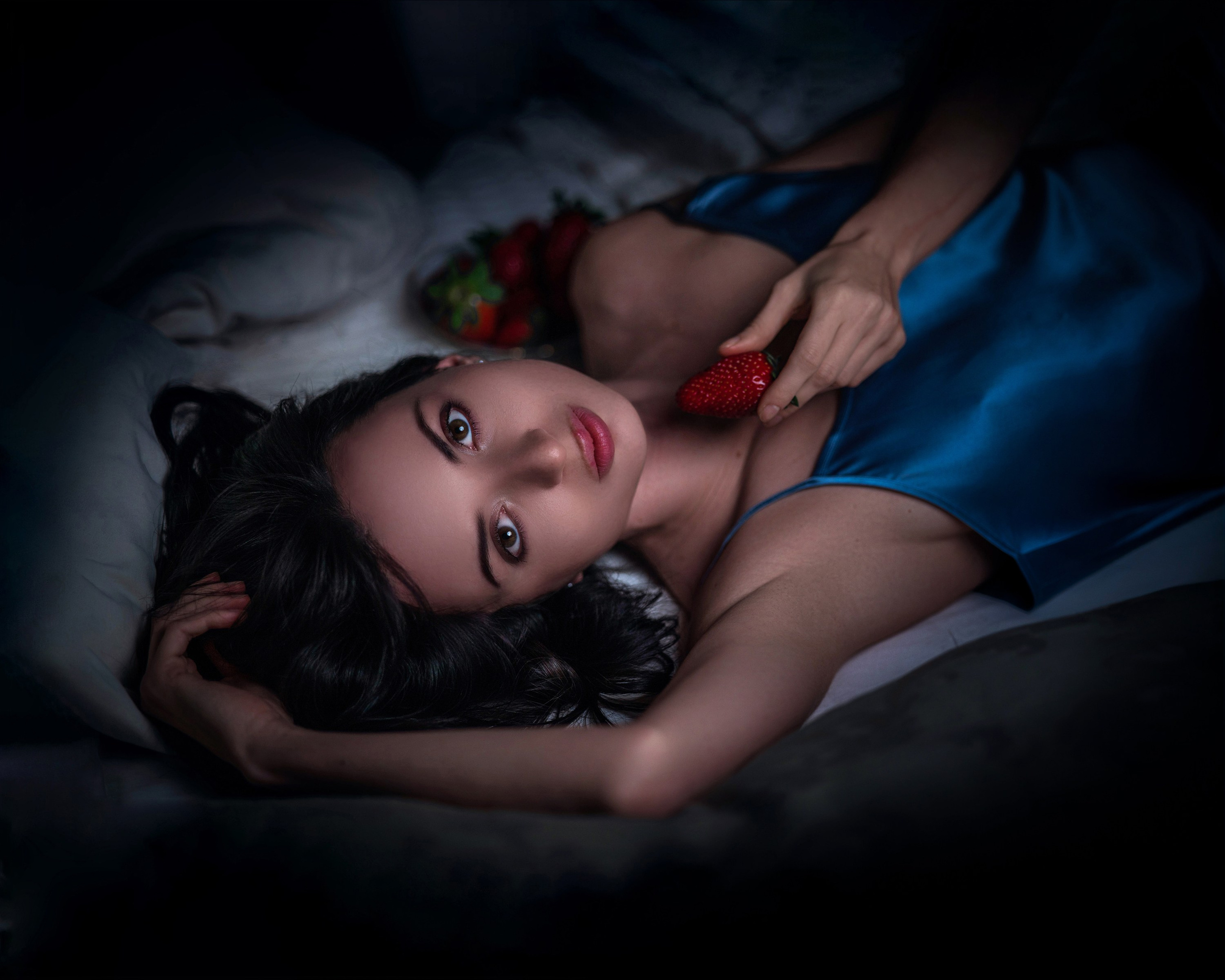 Artistic female portrait with strawberry shot from above