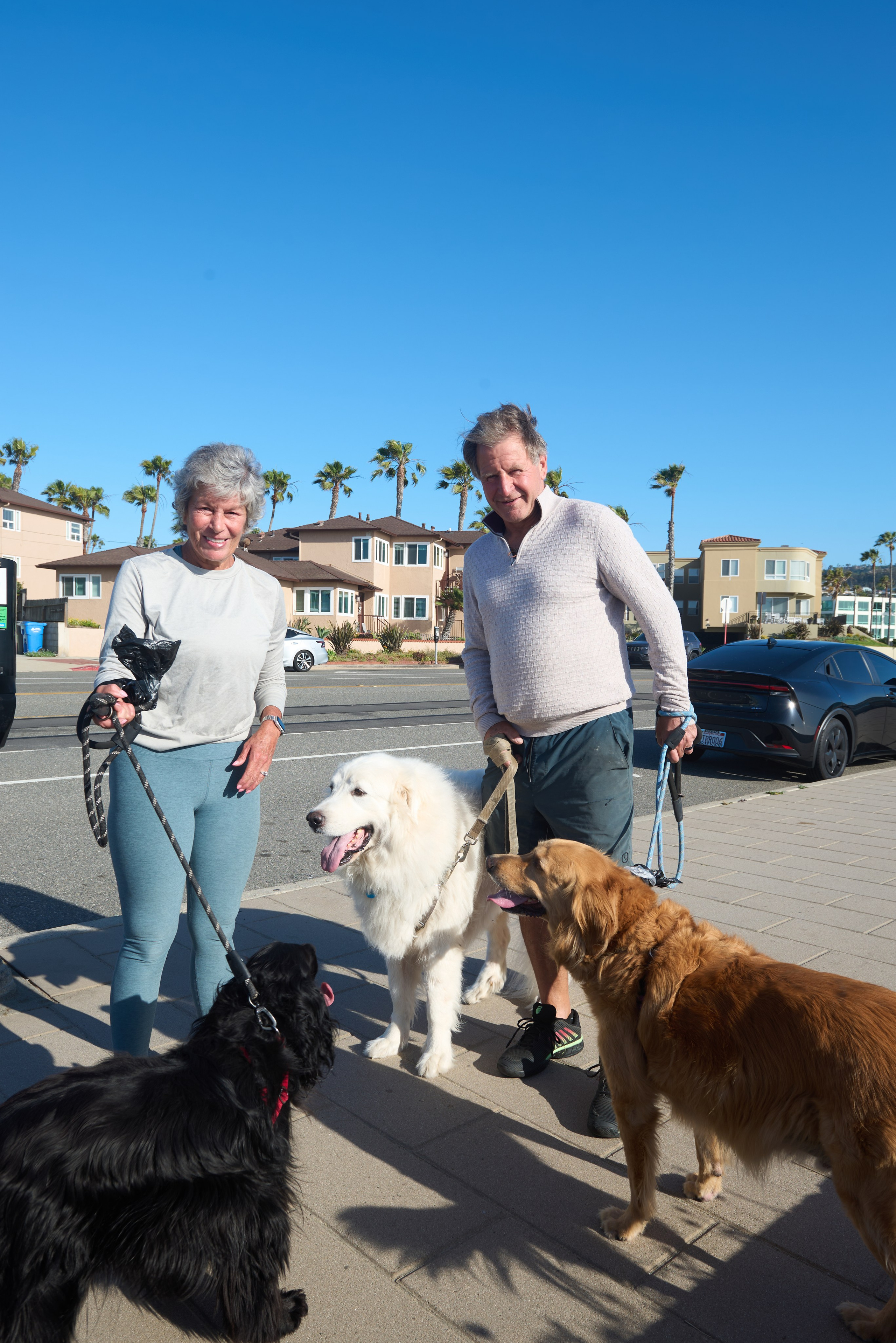 Woman hugging her golden retriever during a sunset photoshoot in Redondo Beach, California