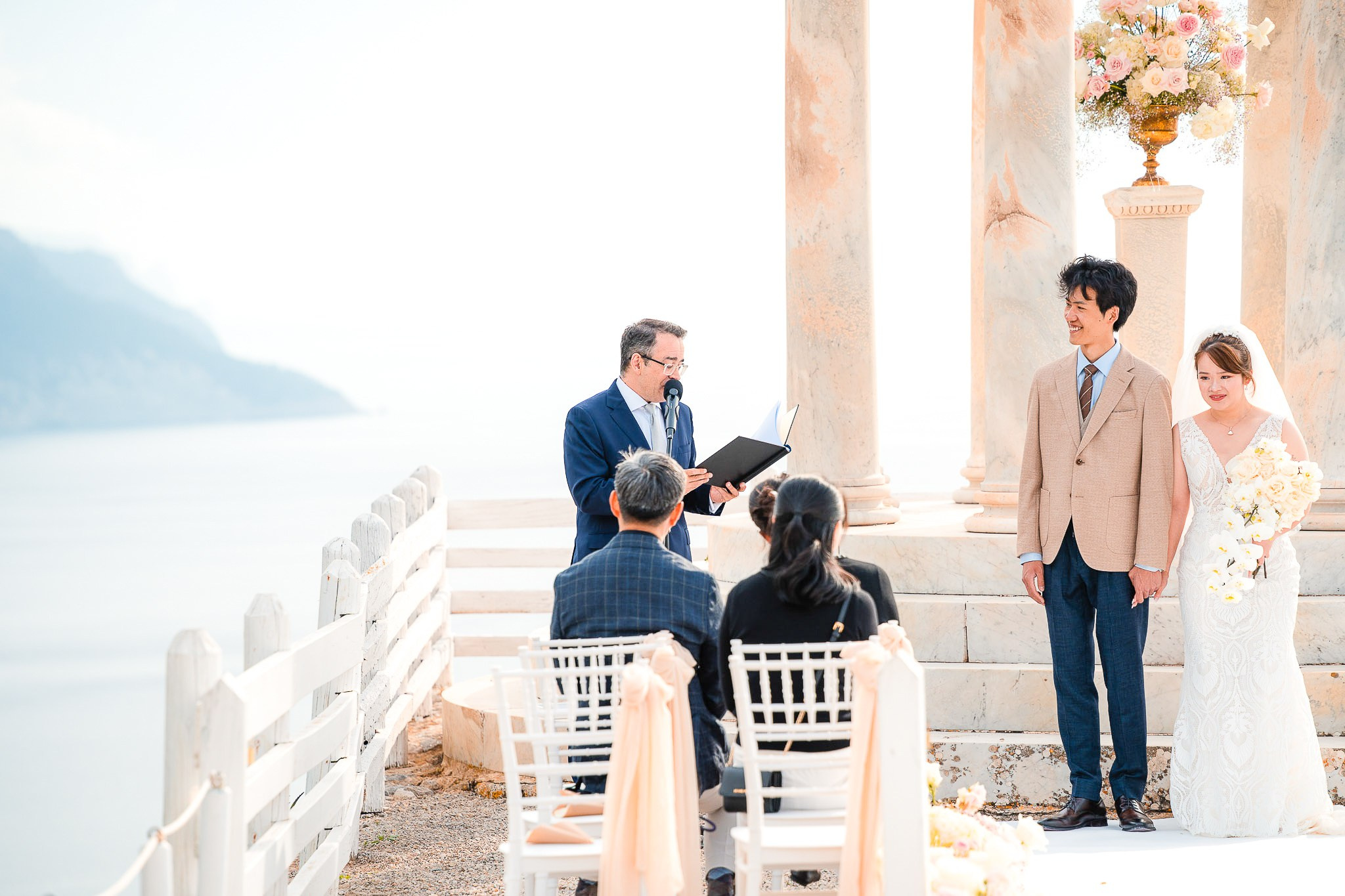 Wedding celebrant reading vows as bride and groom stand at their Son Marroig ceremony