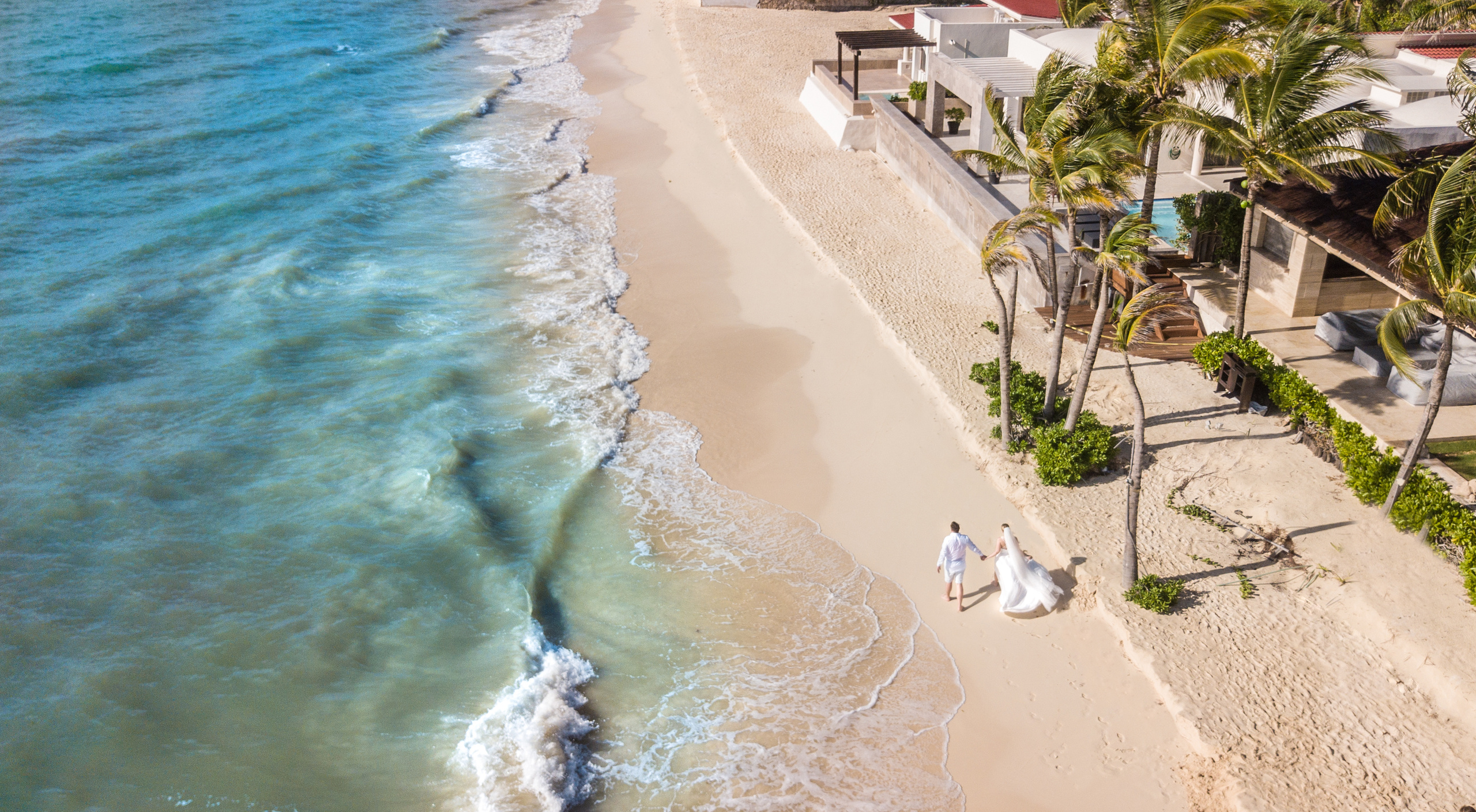 Romantic vow exchange in front of turquoise ocean