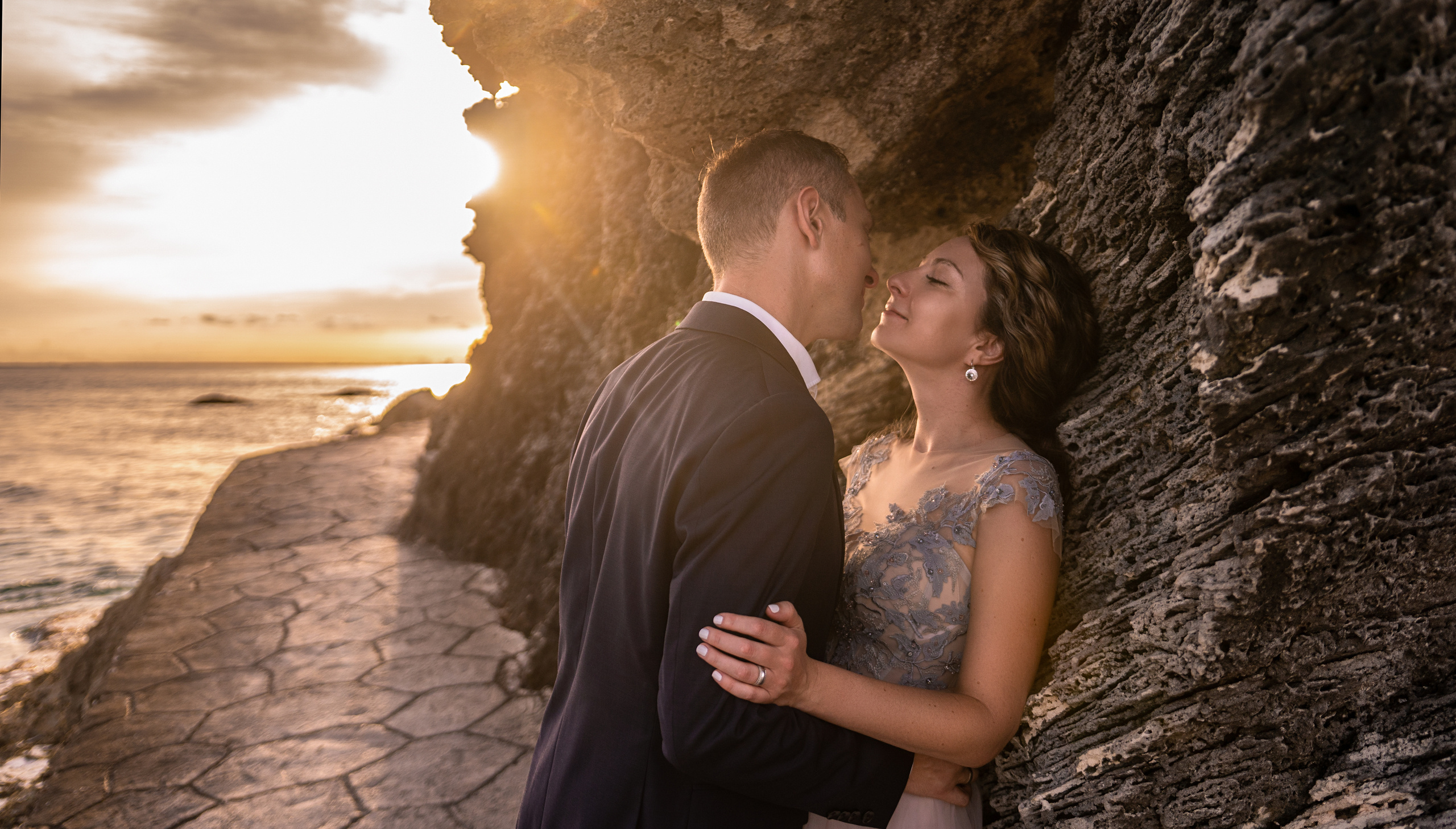 Sunset engagement photo on rocky coast of Isla Mujeres, Mexico