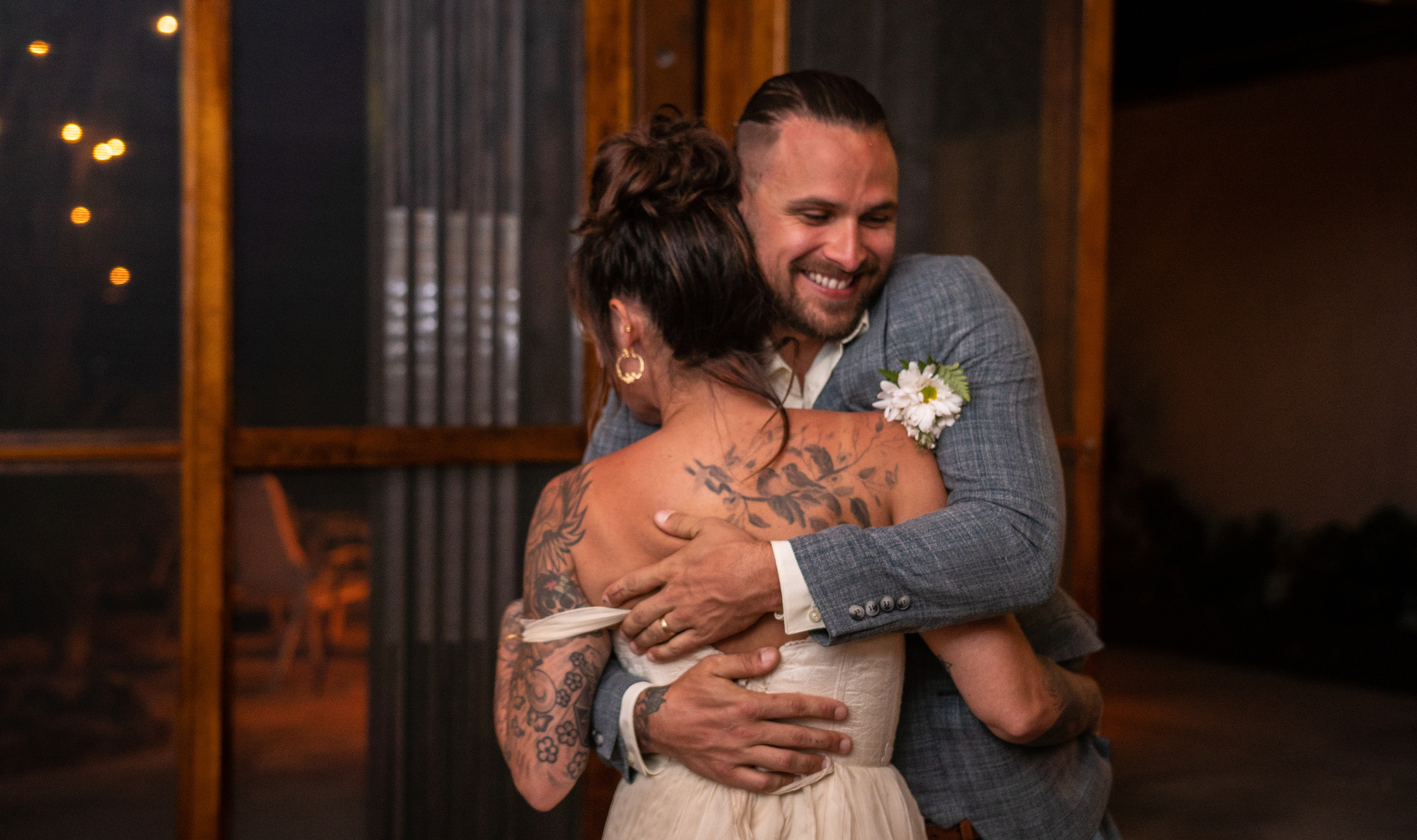 Tattooed bride and groom dancing their first dance in Isla Mujeres – romantic wedding photo by Victoria Liskova
