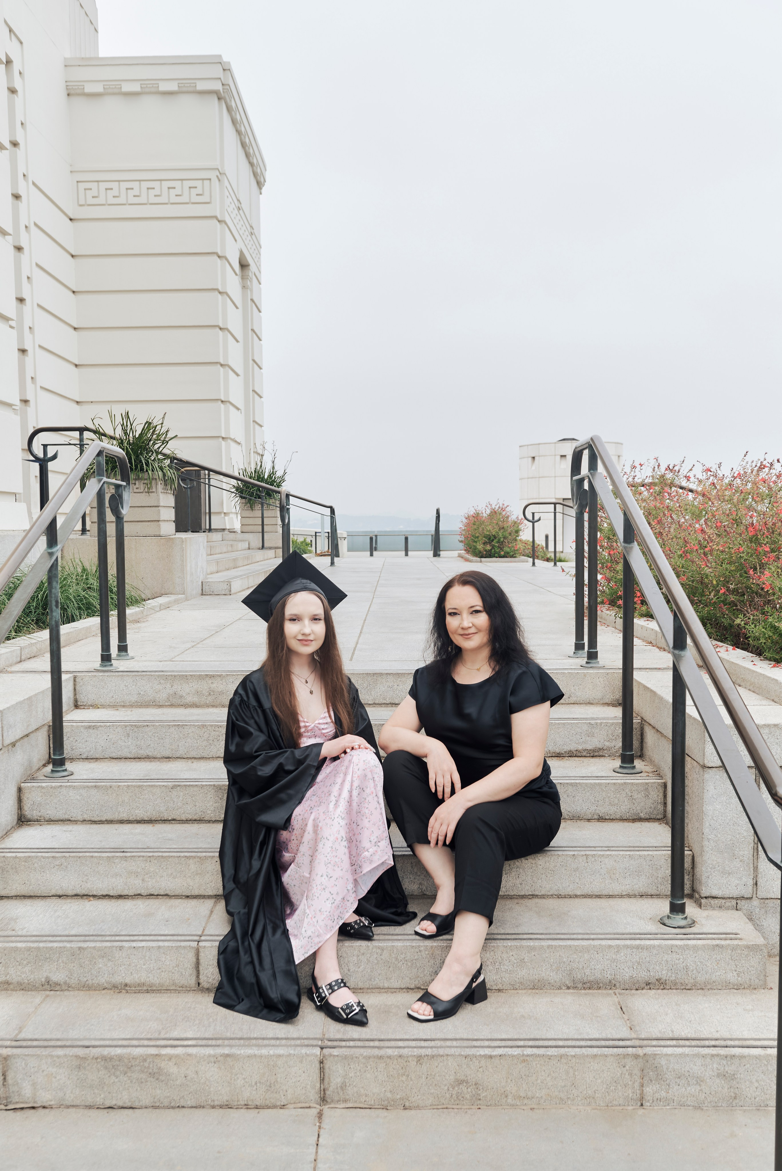 Proud graduate posing in front of a modern Los Angeles building