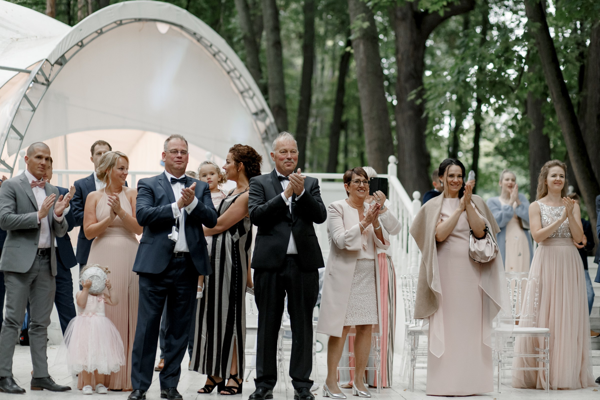 Guests smiling at ceremony, by Bude, Cornwall wedding photographer.