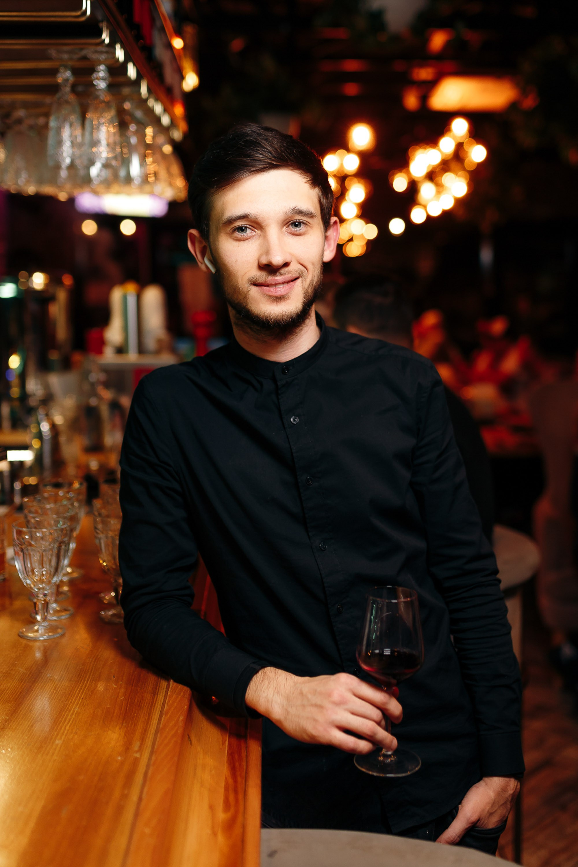 Man posing at bar, stylish portrait