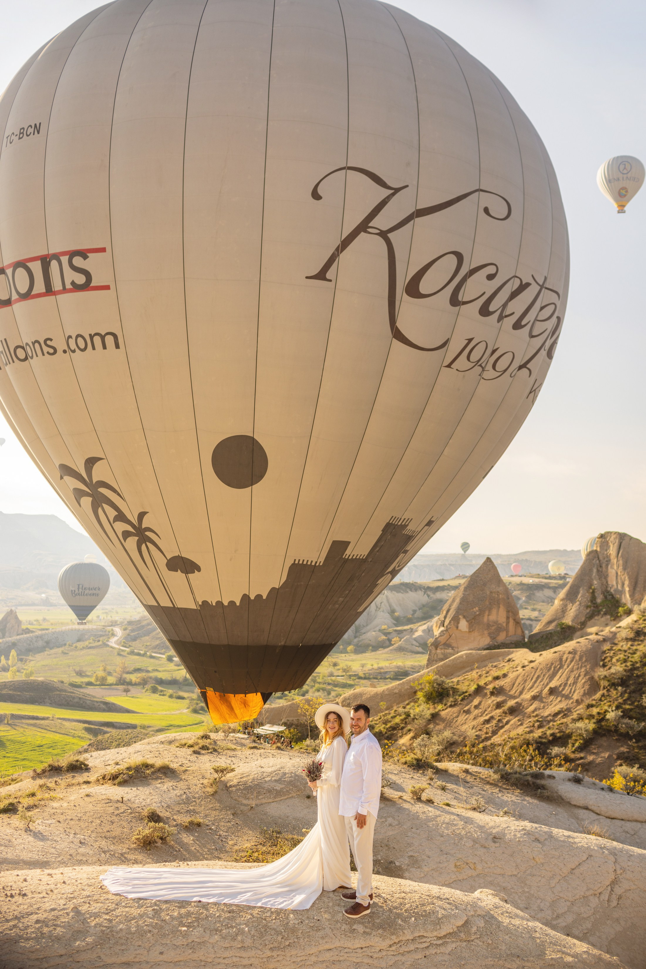 Elegant Wedding Photoshoot with a Flowing Dress and Balloons in Cappadocia. Julia Ganch I Fashion Wedding Photography I Cappadocia Turkey