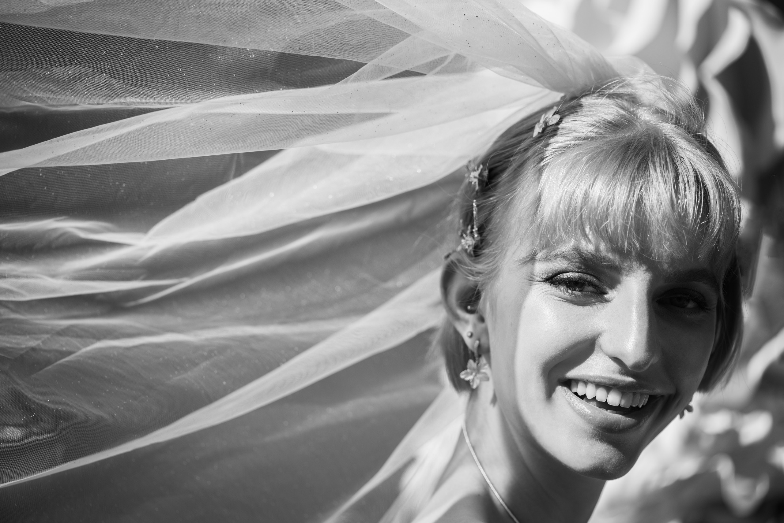 A happy and beautiful bride is laughing. Black and white photography