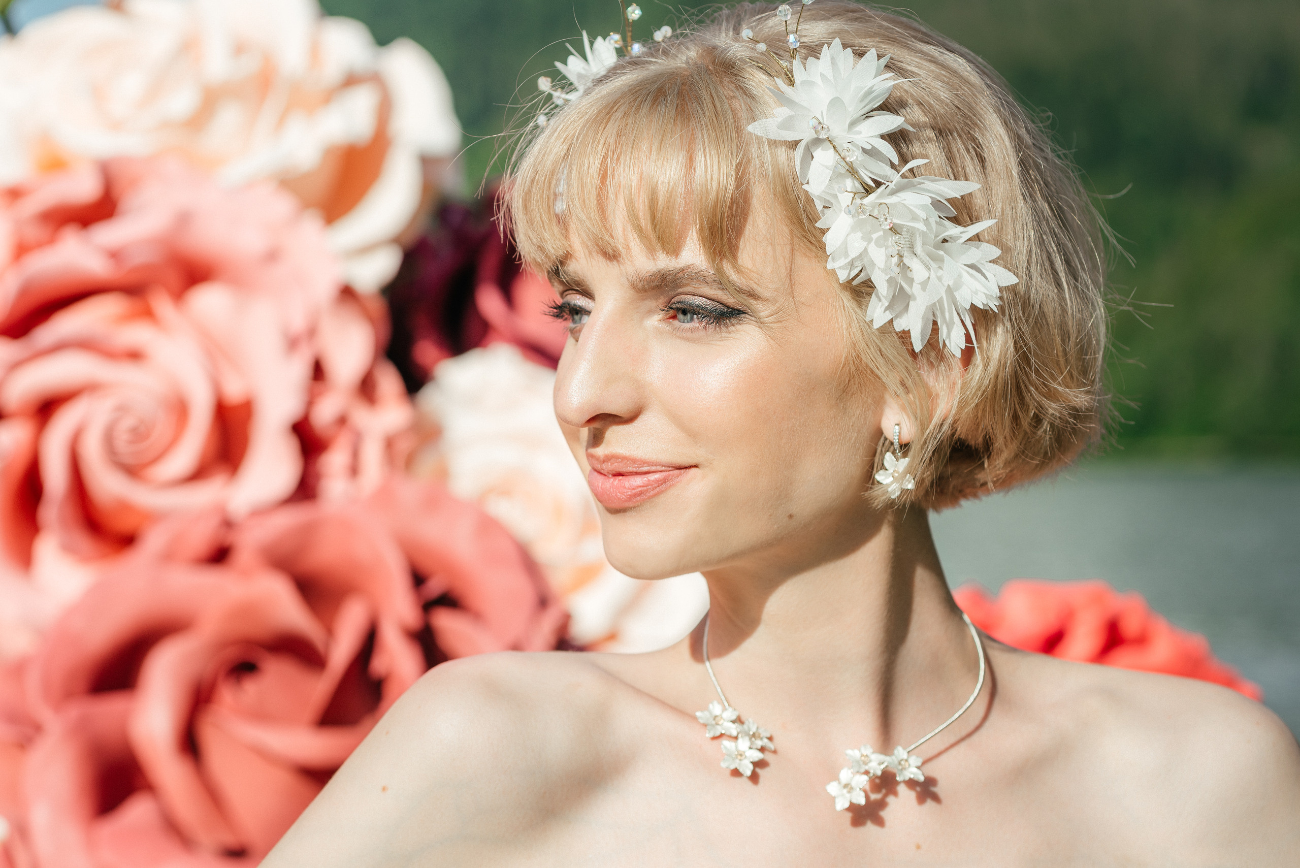 A happy and beautiful bride is waiting for her fiance in big flowers