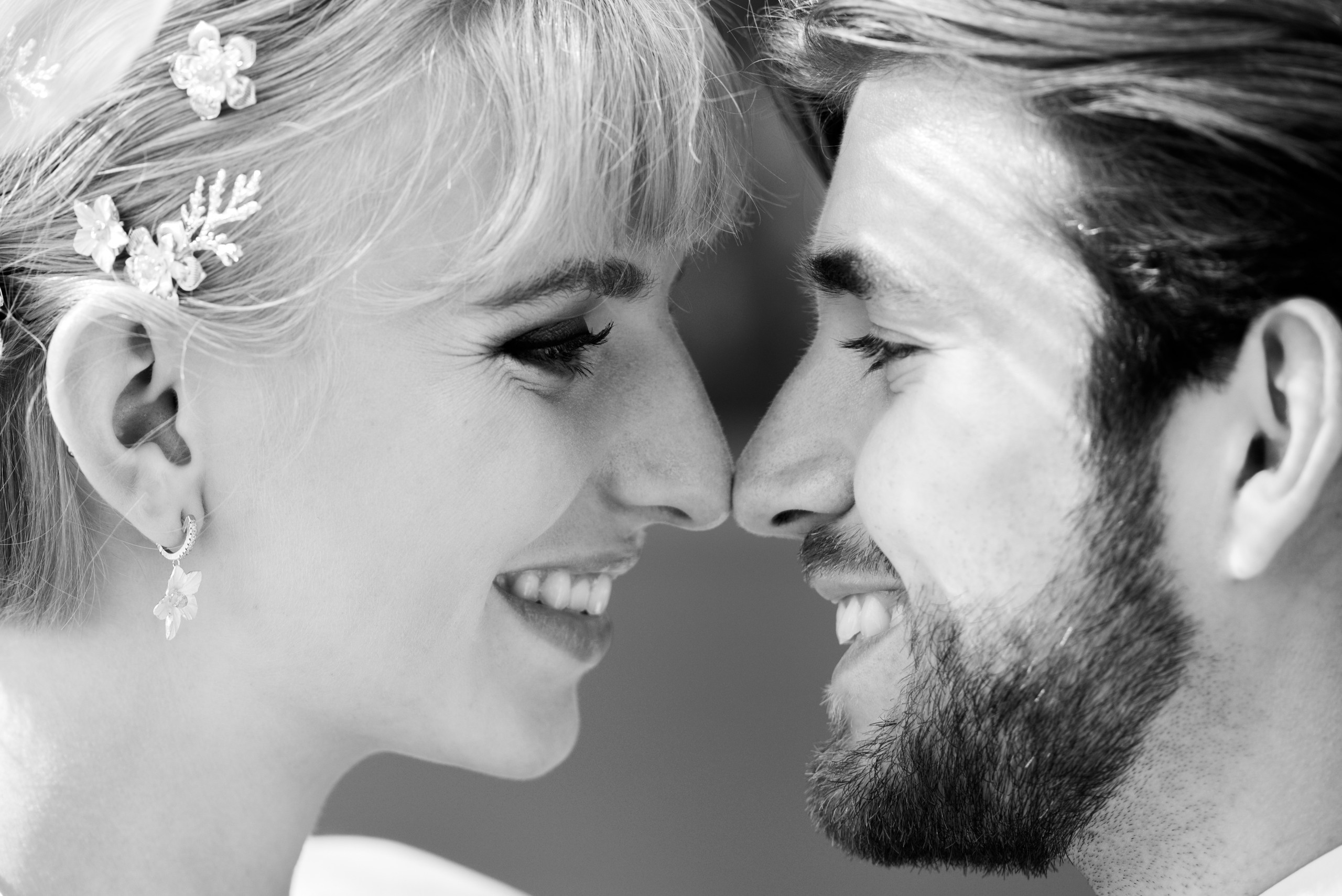 A romantic wedding couple is looking to each other and laughing. Black and white photography