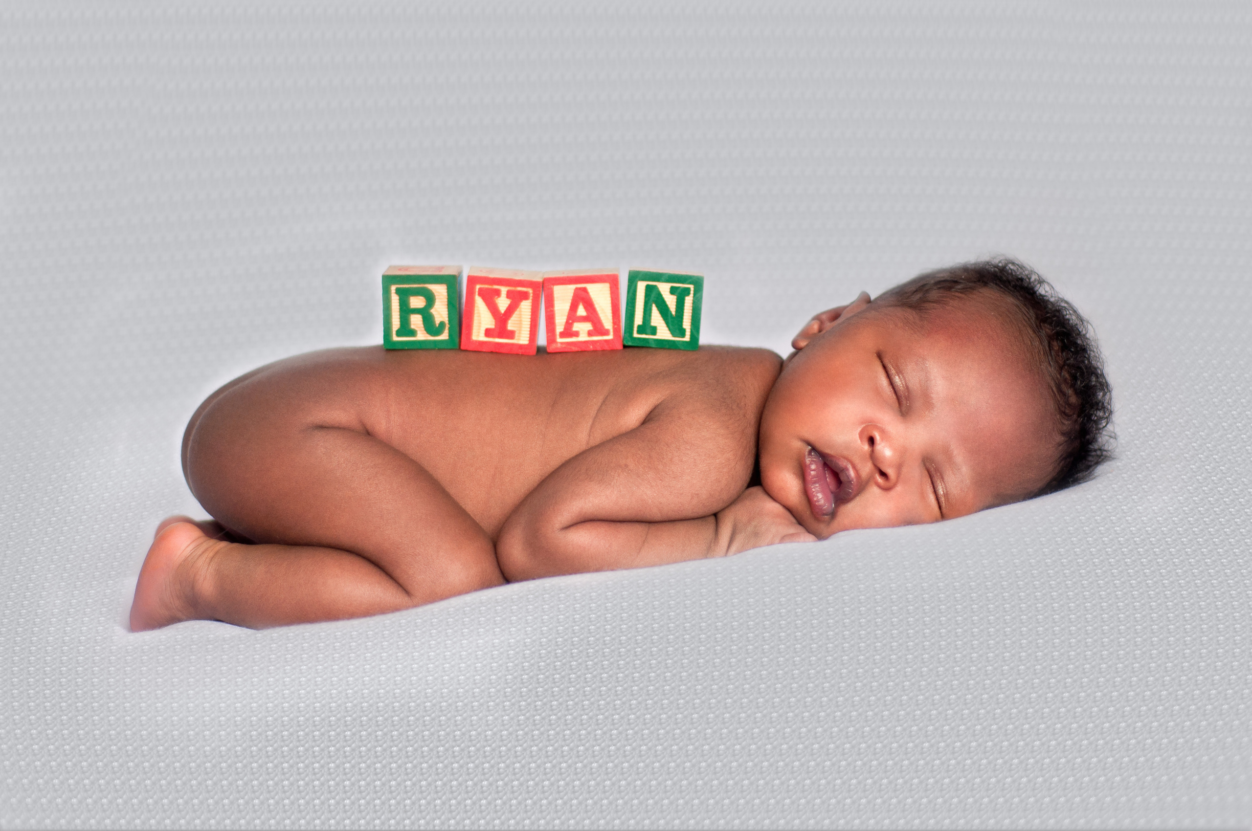 Black Uganda newborn boy with name on back photo shoot Nairobi Kenya