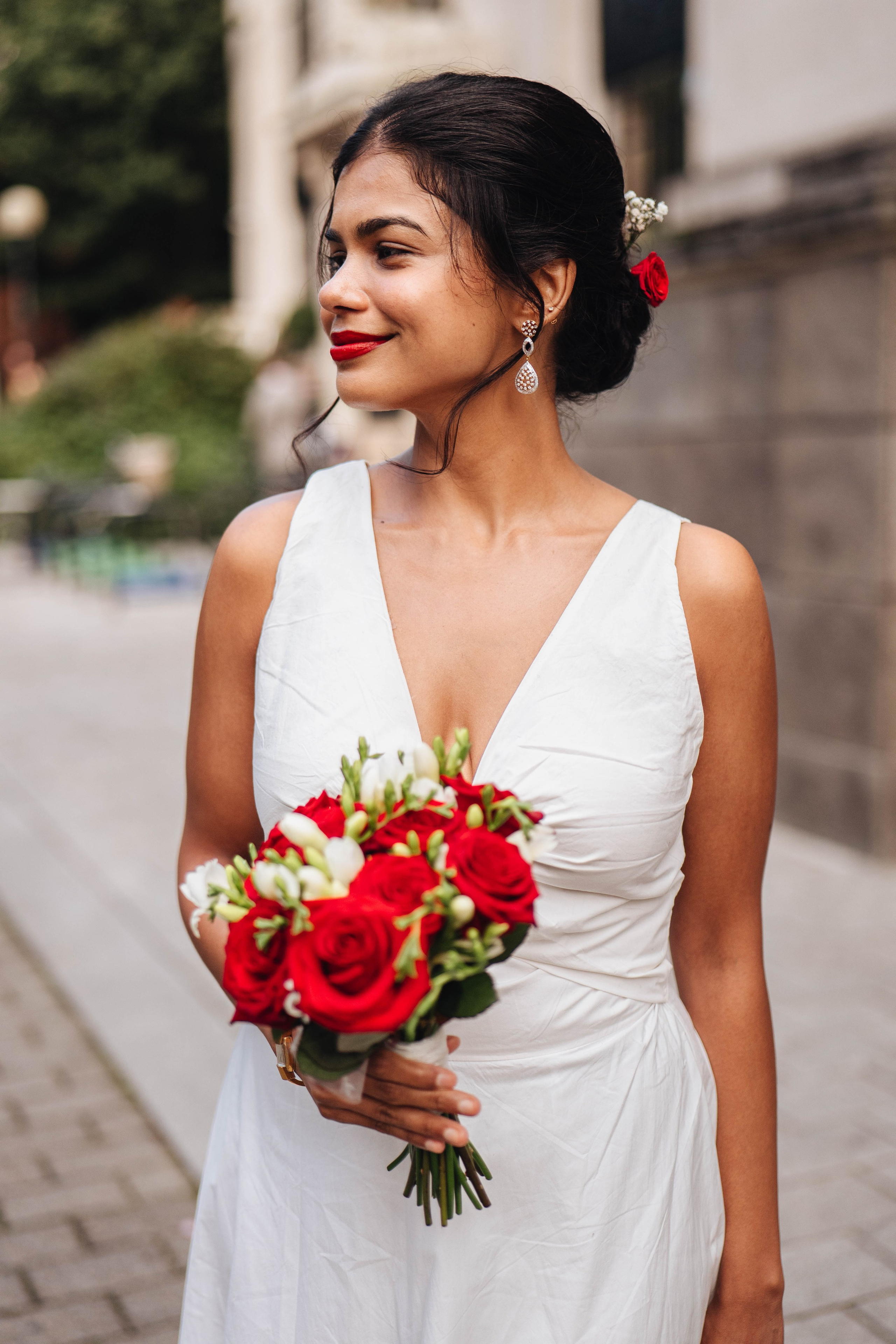 Wedding photography in london, bride close up, red flowers