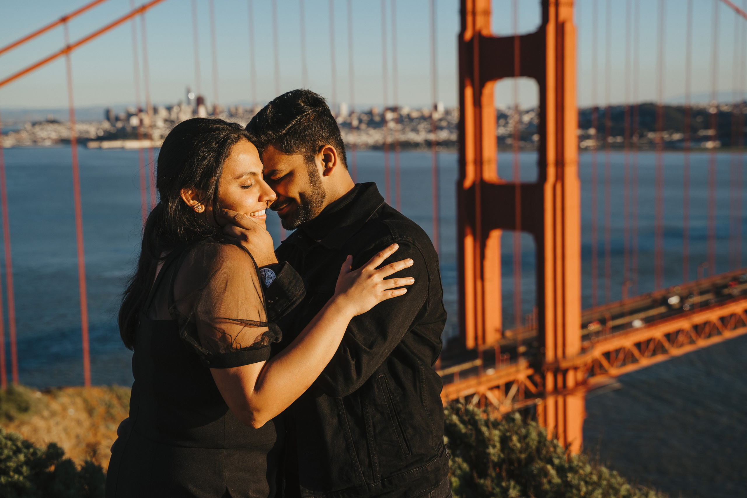 Proposal.  Overlooking the golden San Franisco Bridge sunset with a couple. Photographer Video. 