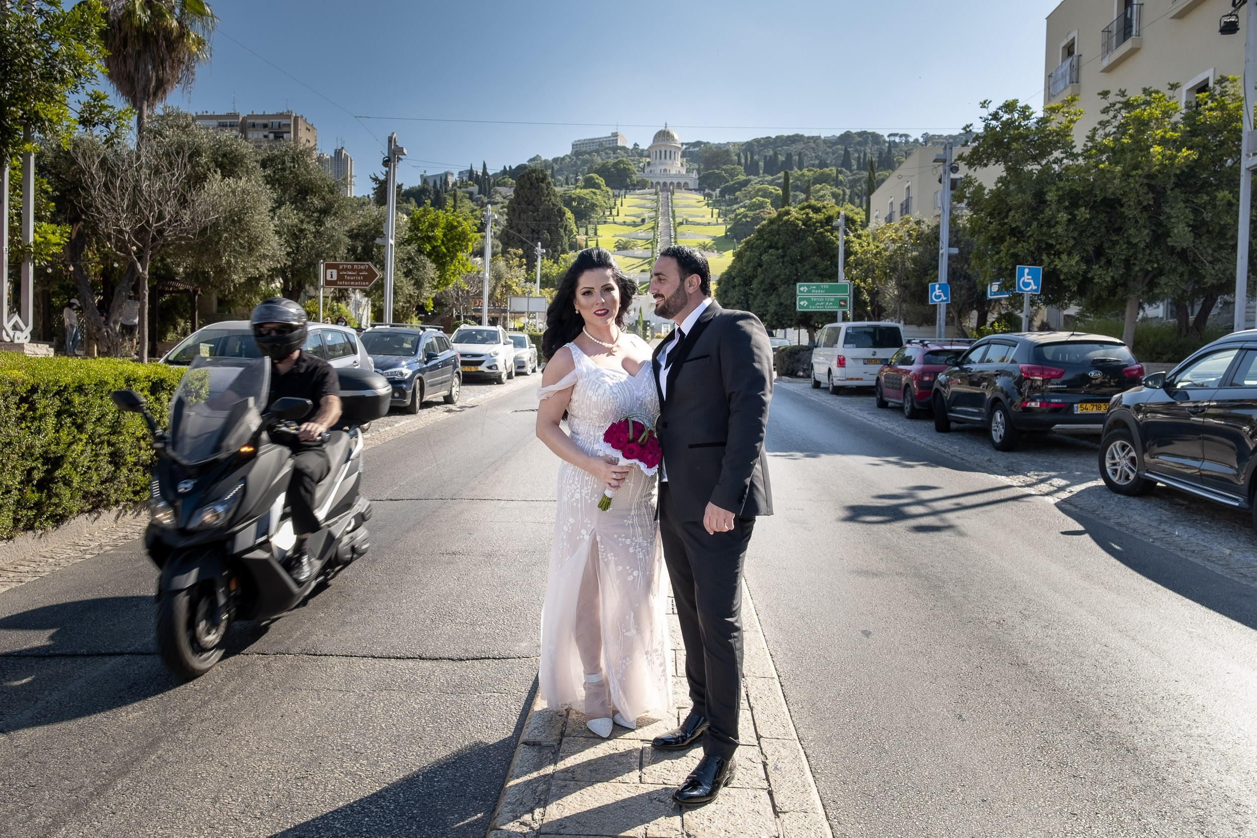 Sara and Emil stand together with the Bahá’í Gardens in the background