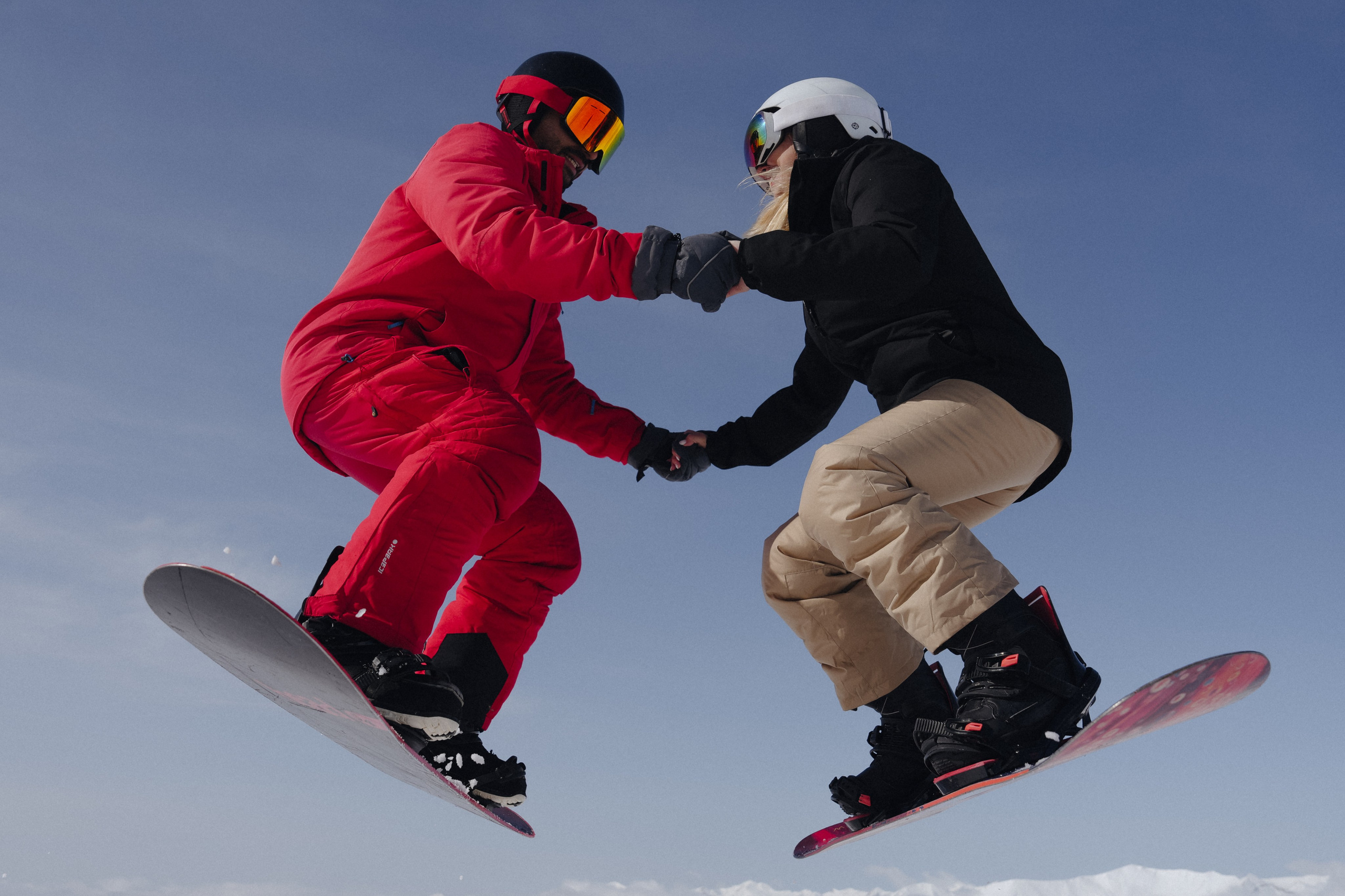 Snowboard proposal moment with Caucasus mountains behind in Gudauri