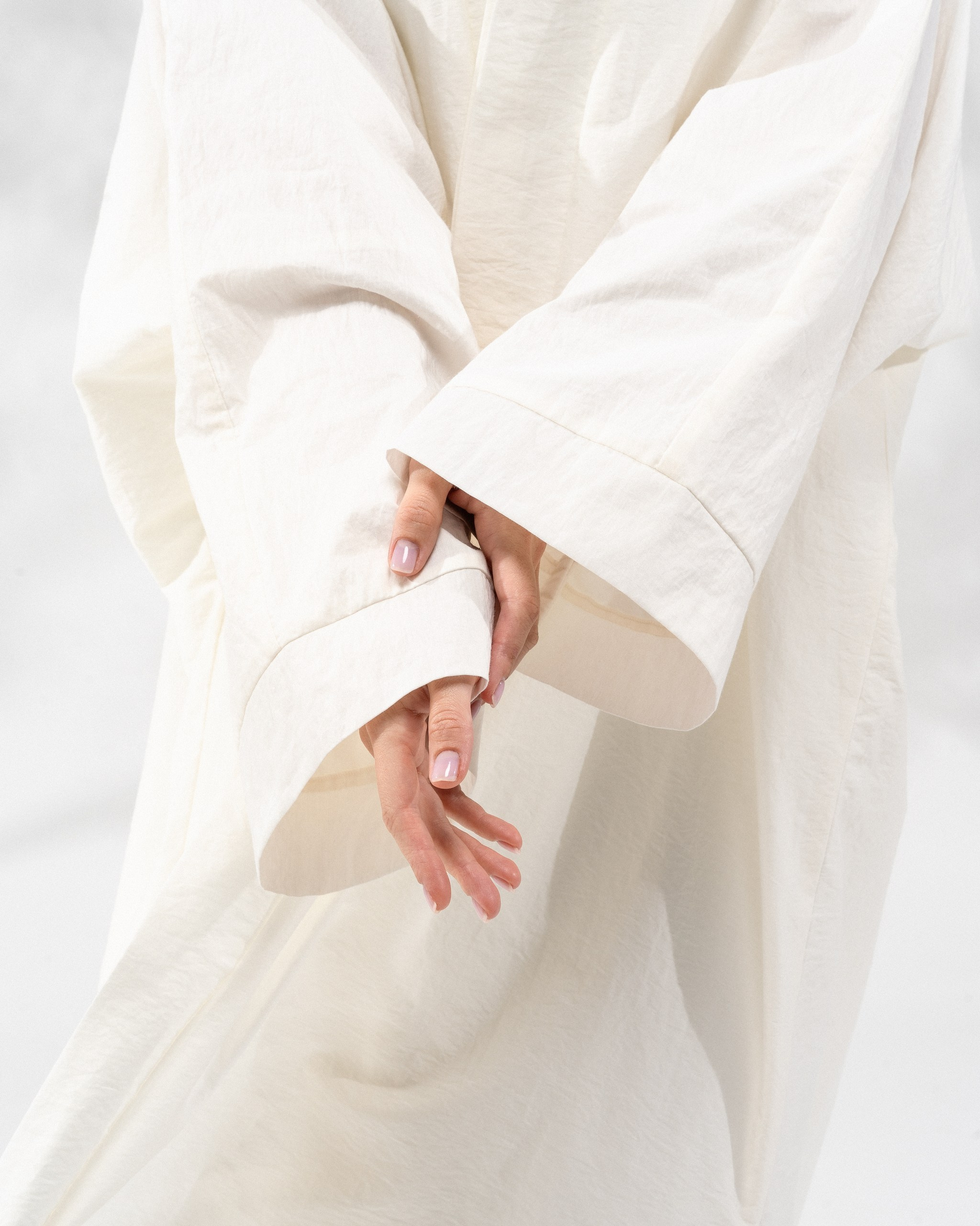 Contemporary apparel focus showing textured fabric and relaxed sleeve silhouette