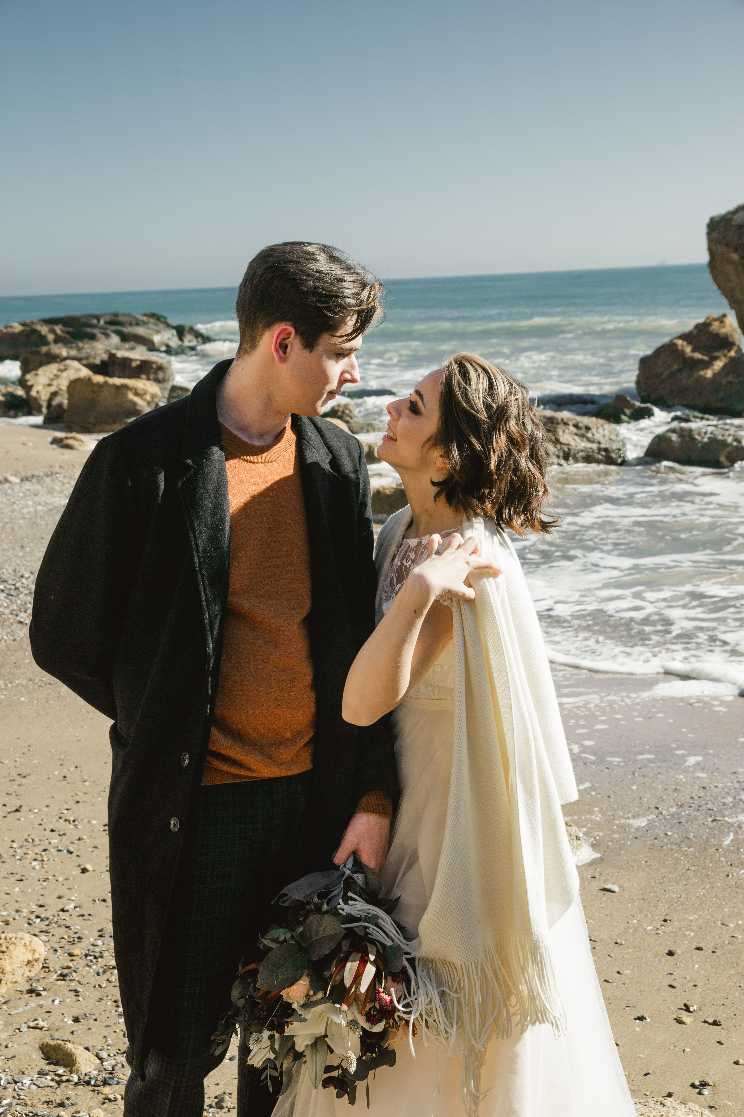 Romantic couple embracing by the seaside cliffs, Mediterranean wedding Greece