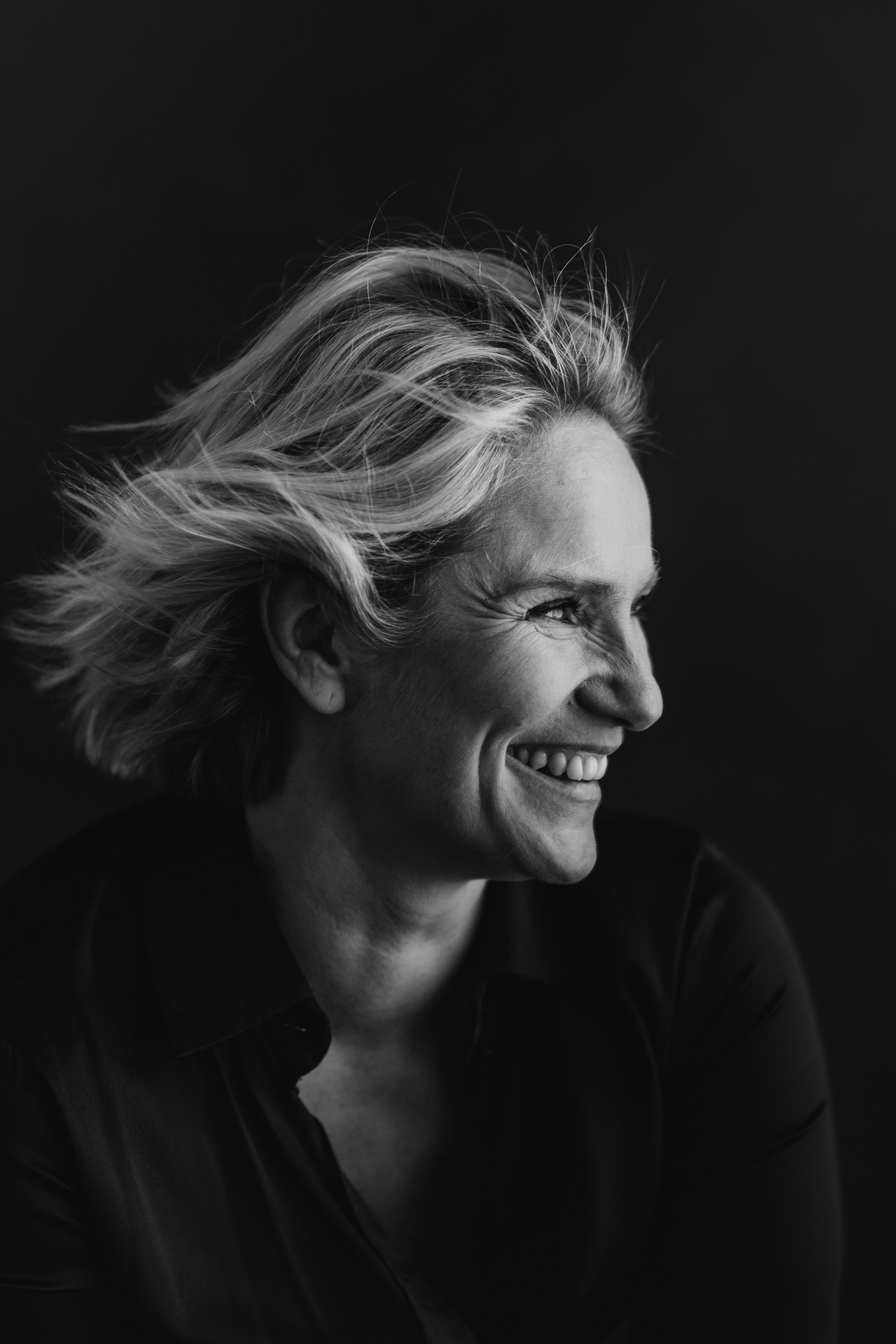 Laura  Malmivaara dramatic actor headshot low key lighting Finland