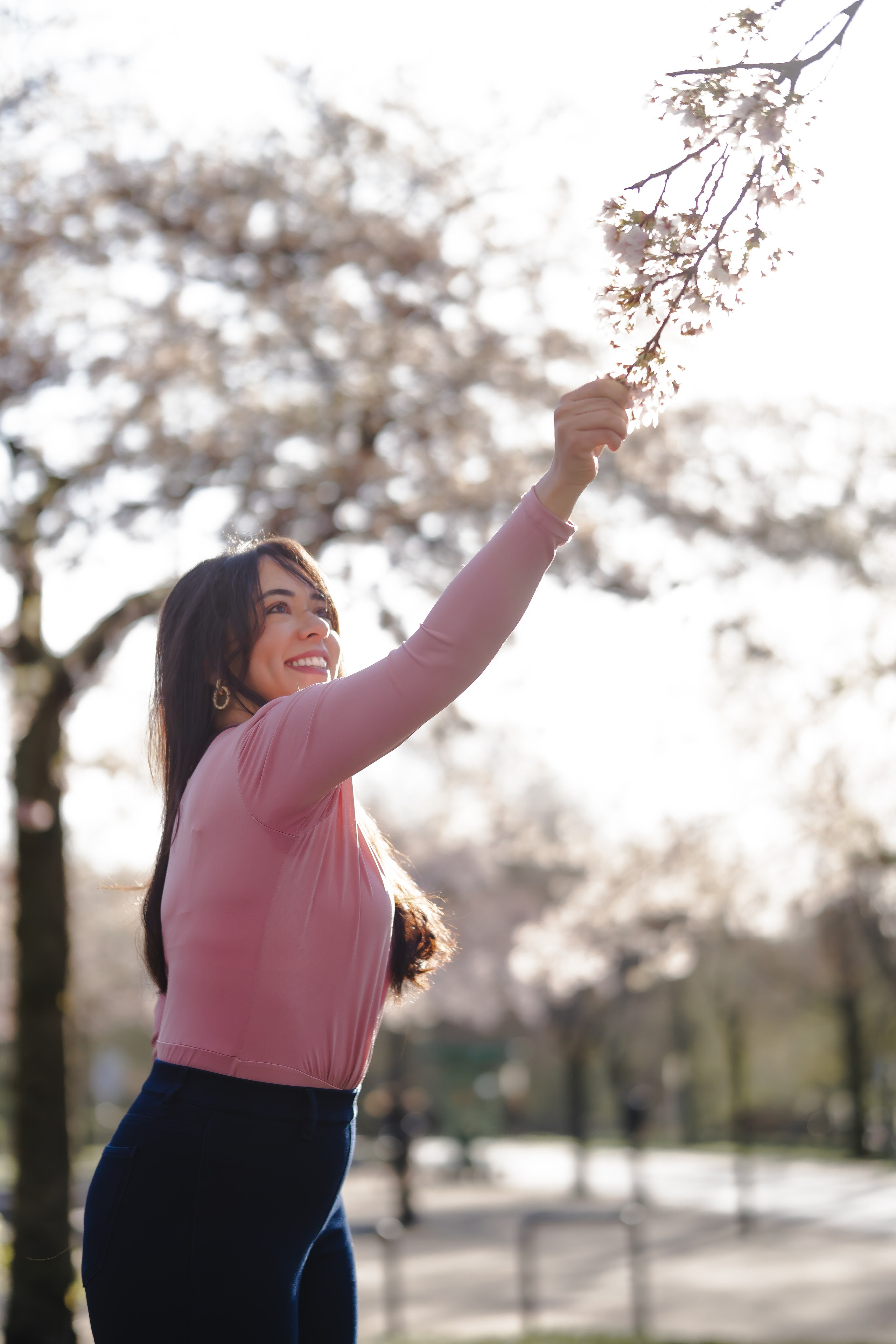 girl holding a cherry blossoms branch